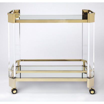 Charlevoix Serving Cart by Butler Specialty Company in gold and polished gold. Made from stainless steel, high polished gold, acrylic, clear glass, mirror glass, stainless steel casters, high polished gold finish in a tran