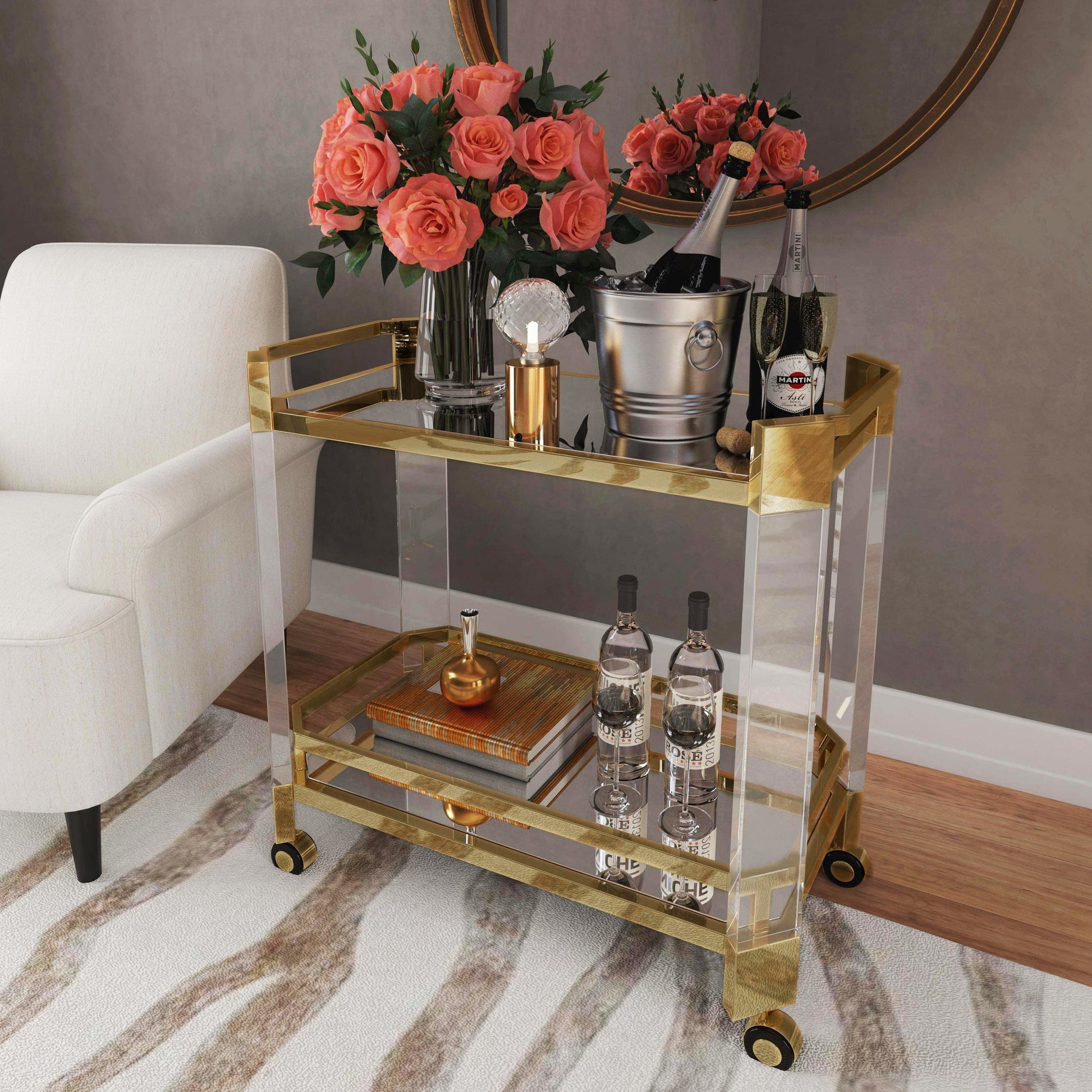Charlevoix Serving Cart by Butler Specialty Company in gold and polished gold. Made from stainless steel, high polished gold, acrylic, clear glass, mirror glass, stainless steel casters, high polished gold finish in a transition