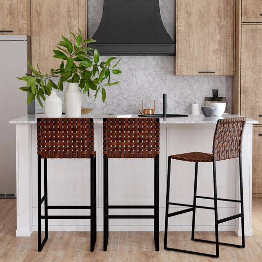 Urban Bar Stool by Butler Specialty Company in medium brown and brown leather. Made from iron, real leather, steel metal nail heads in a modern style.