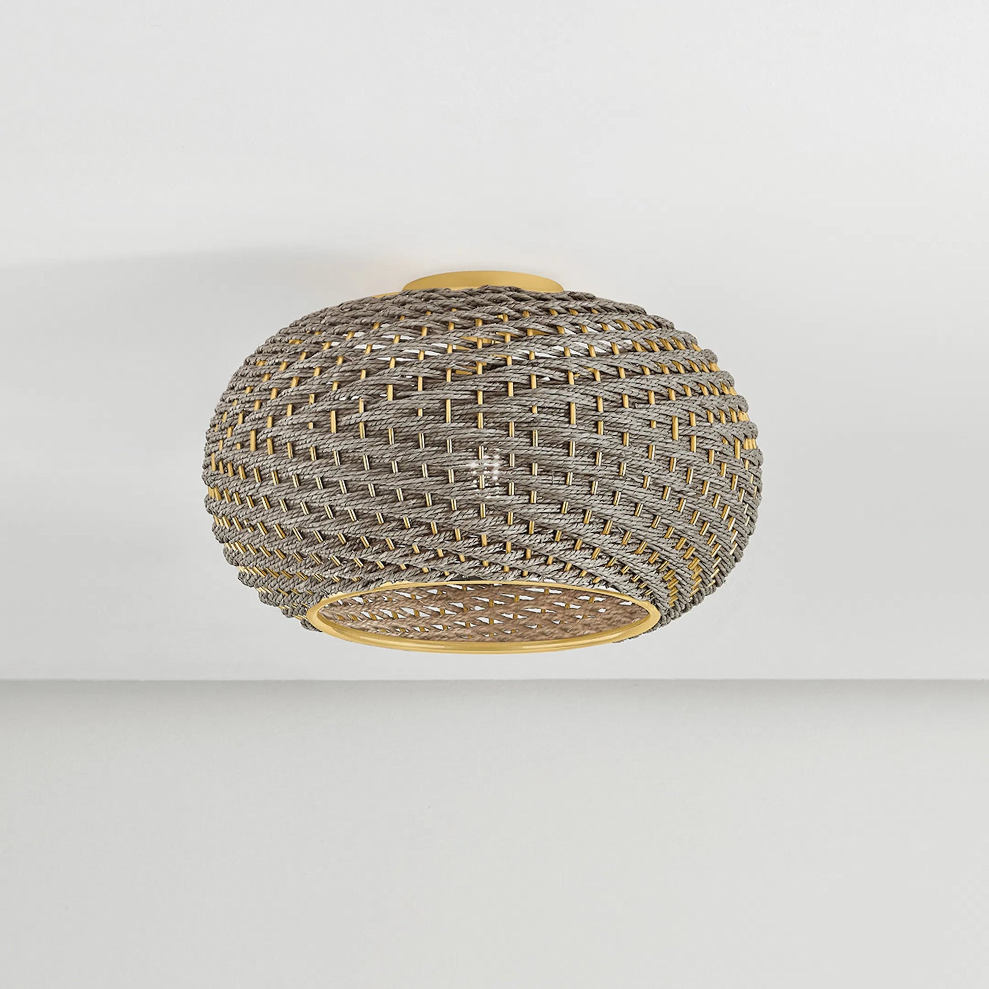Penarth Flush Mount by Hudson Valley in aged brass. Made from natural woven in a rustic style.