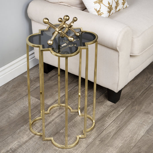 Auroria Accent Table by Butler Specialty Company in black,gold and antique gold. Made from stainless steel, black glass in a transitional style.