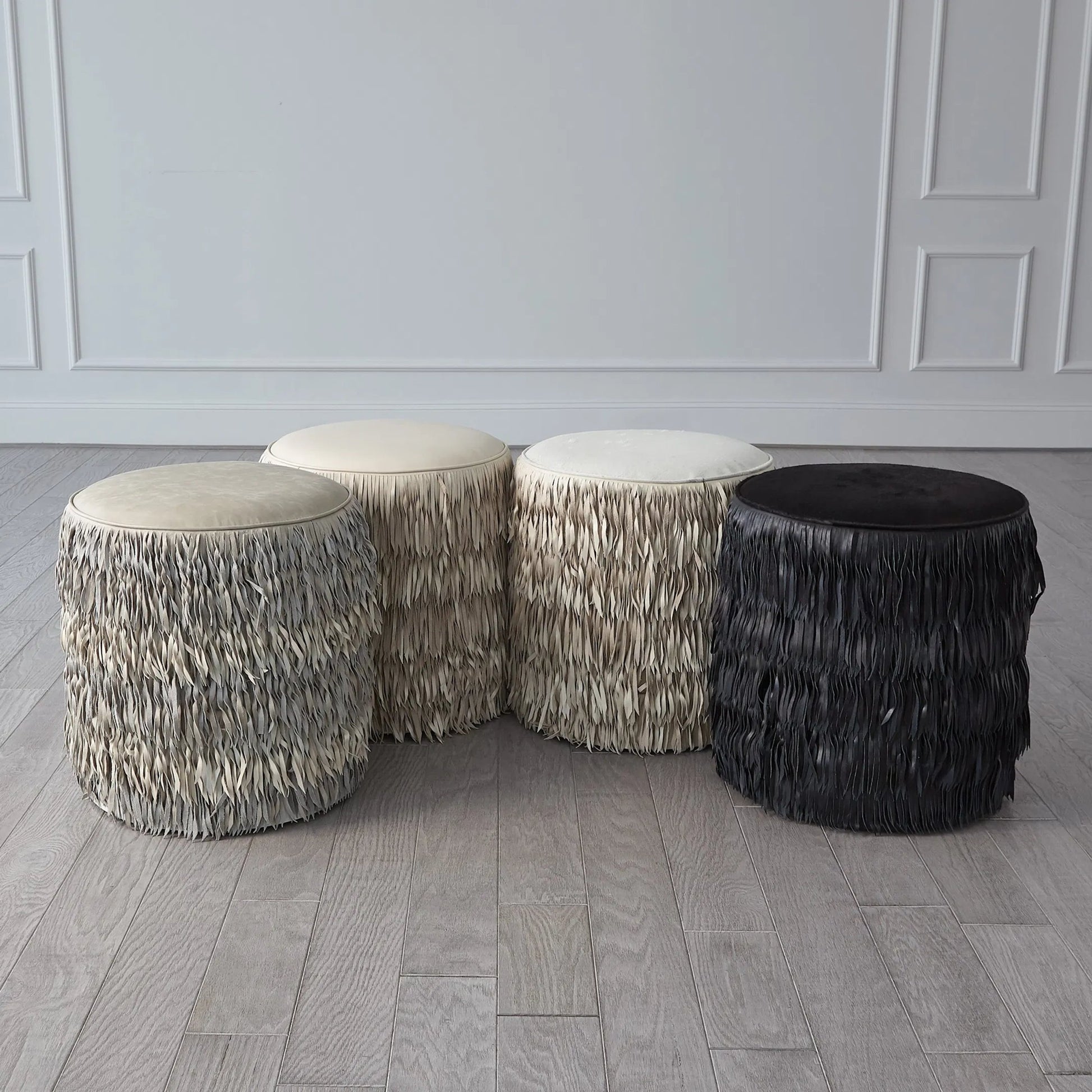 Fringe Ottoman by Global Views. Made from mdf, leather, pvc in a unique style.