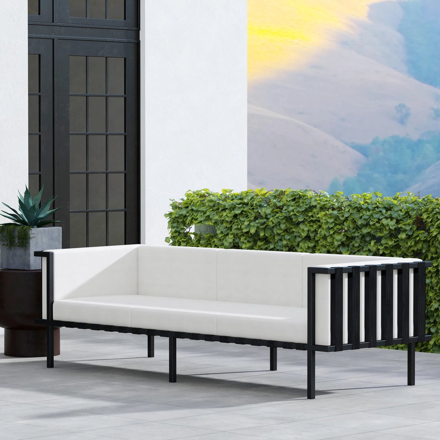 007 SI-2077818 | Lifestyle | Norway Outdoor Patio Sofa with Cushions by Butler Specialty Company in black and white and black. Made from made from iron, foam, fabric, plyboard and nylon strip in a modern style.