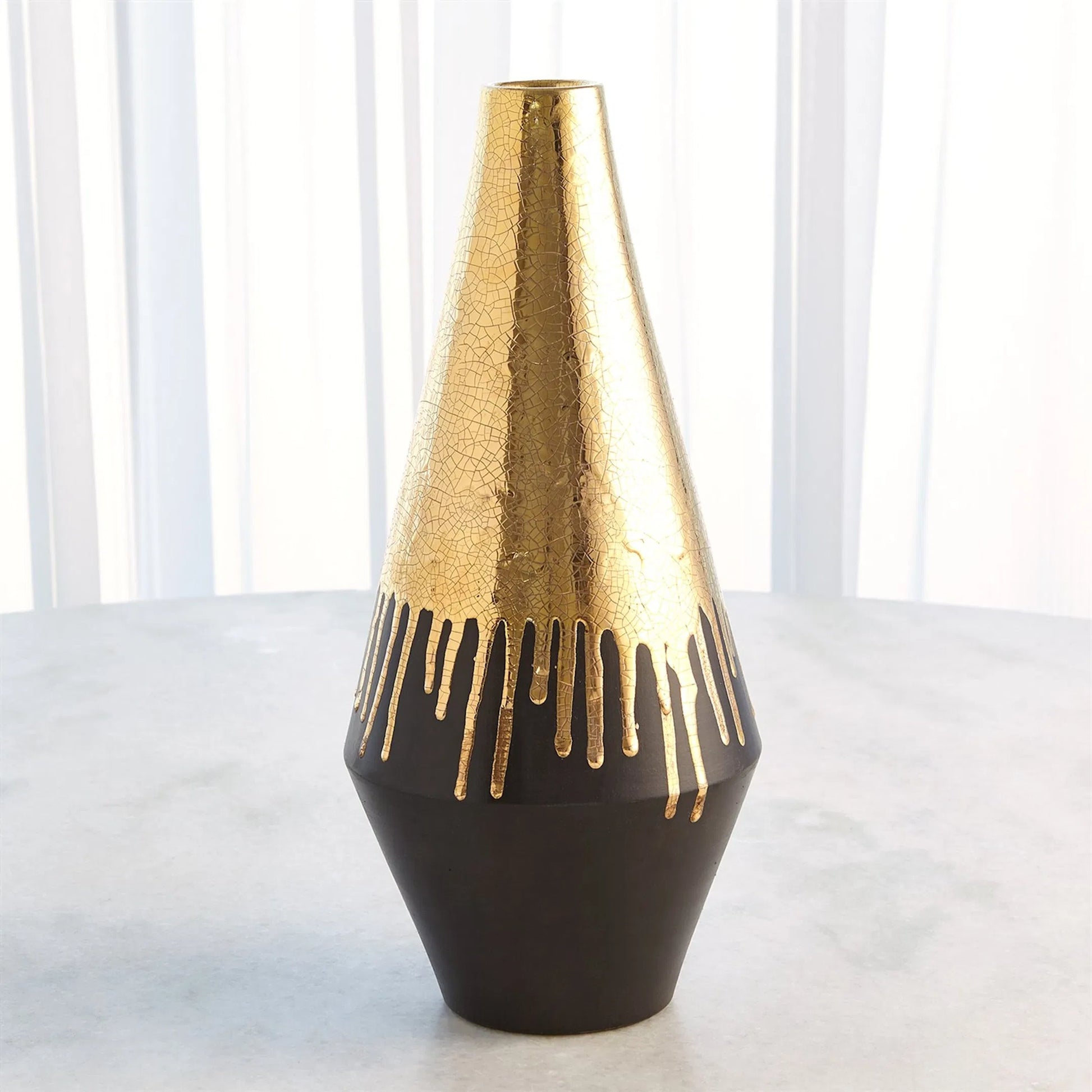 Gold Drip Vase by Global Views in gold. Made from unique in a modern style.