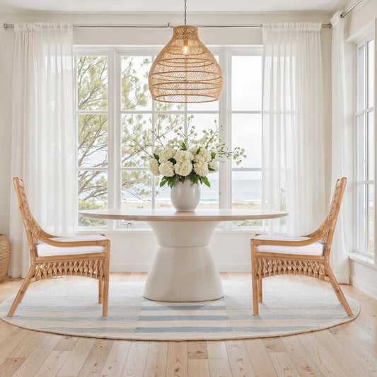 Antigua Dining Chair by Butler Specialty Company in natural rattan. Made from rattan, foam, plywood in a unique style.