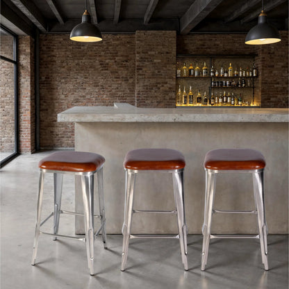 Eastham Bar Stool by Butler Specialty Company in brown leather. Made from iron, leather, engineered wood in a traditional style.