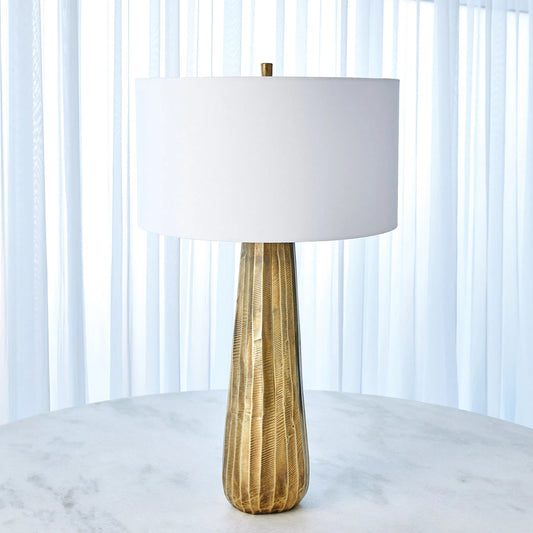 Chased Round Table Lamp by Global Views in antique brass. Made from aluminum in a modern style.
