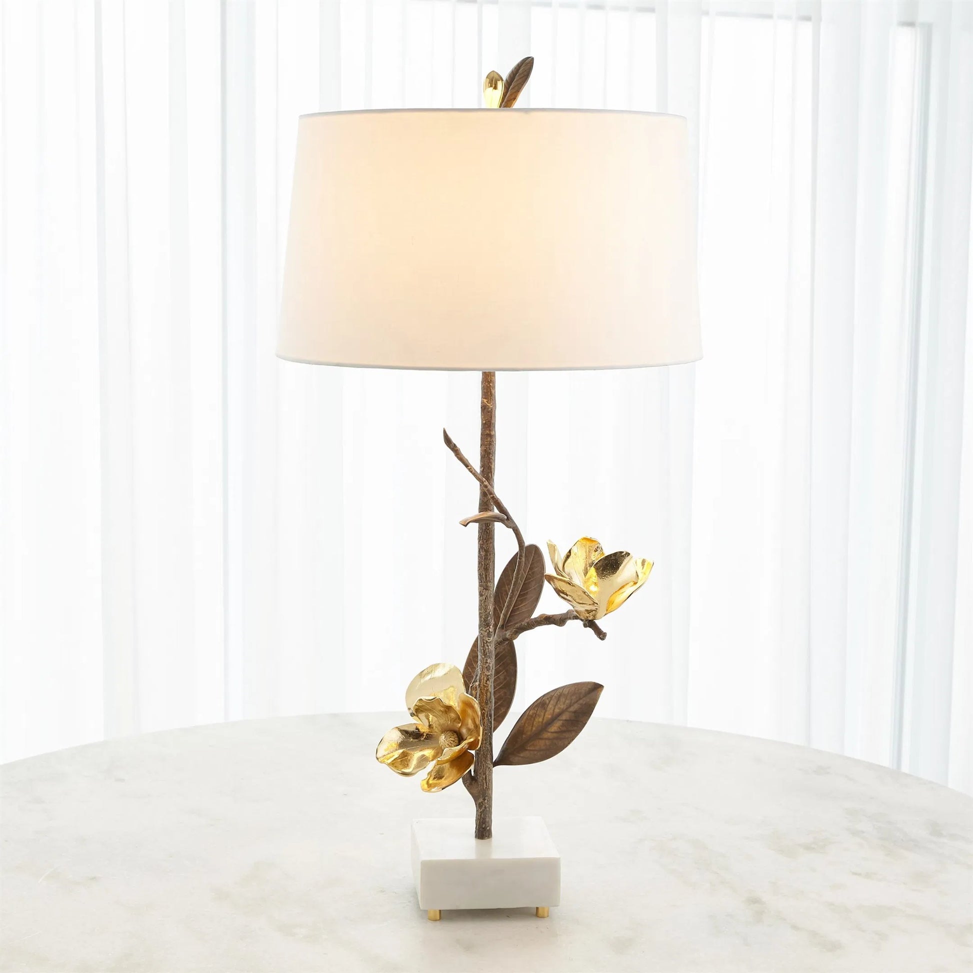 Magnolia Flower Table Lamp by Global Views in antique brass, gold. Made from brass, marble in a modern style.