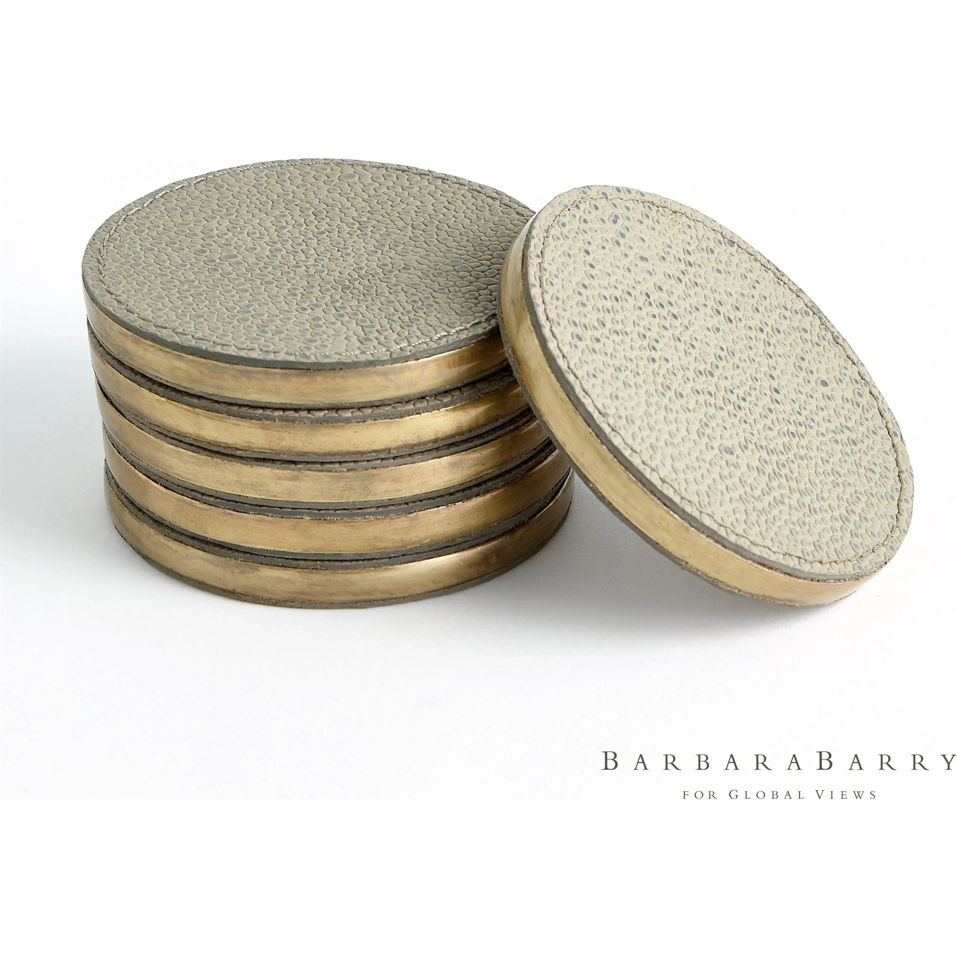 Alpen Coasters by Global Views. Made from mdf, brass, leather, polyester suede in a transitional style.