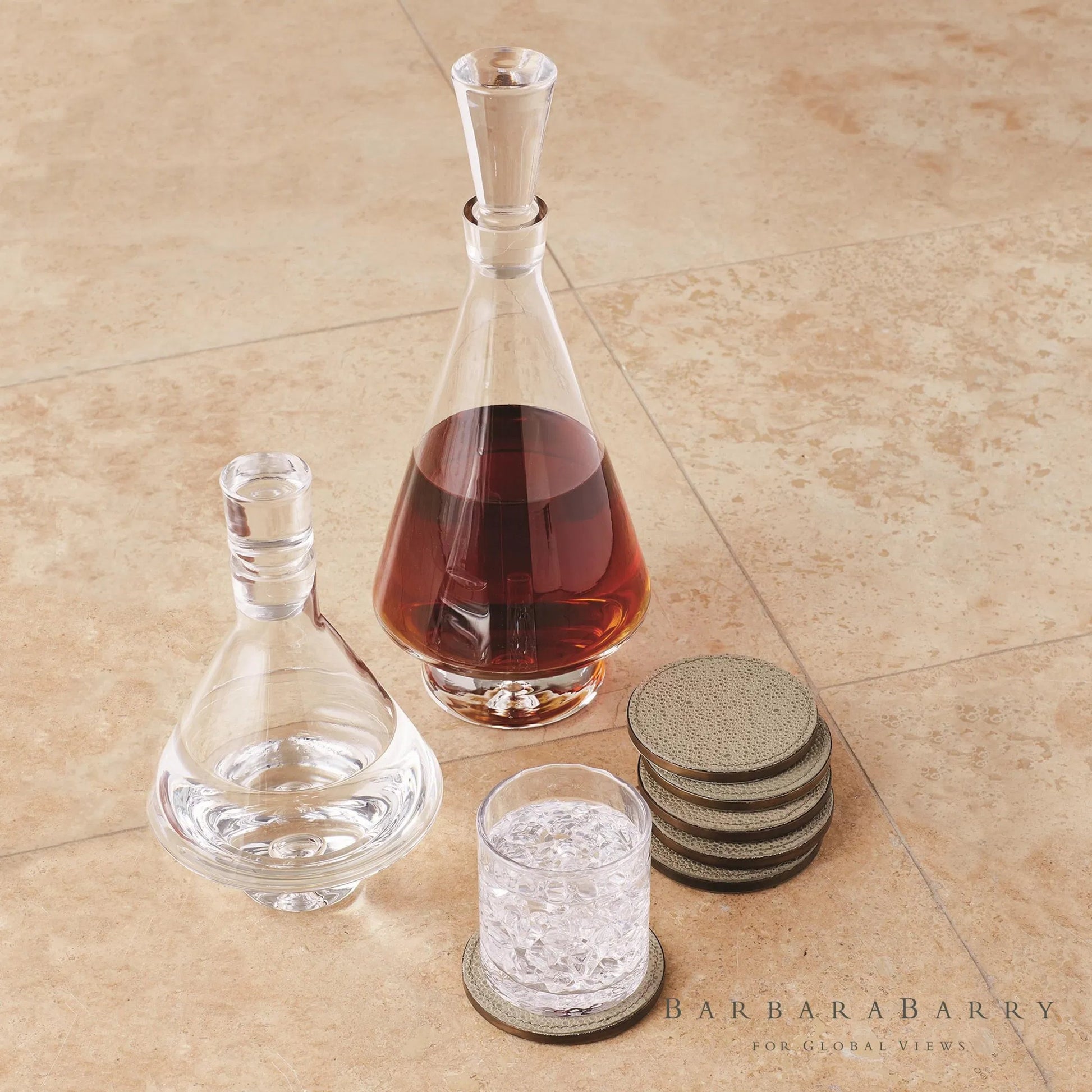 Alpen Coasters by Global Views. Made from mdf, brass, leather, polyester suede in a transitional style.