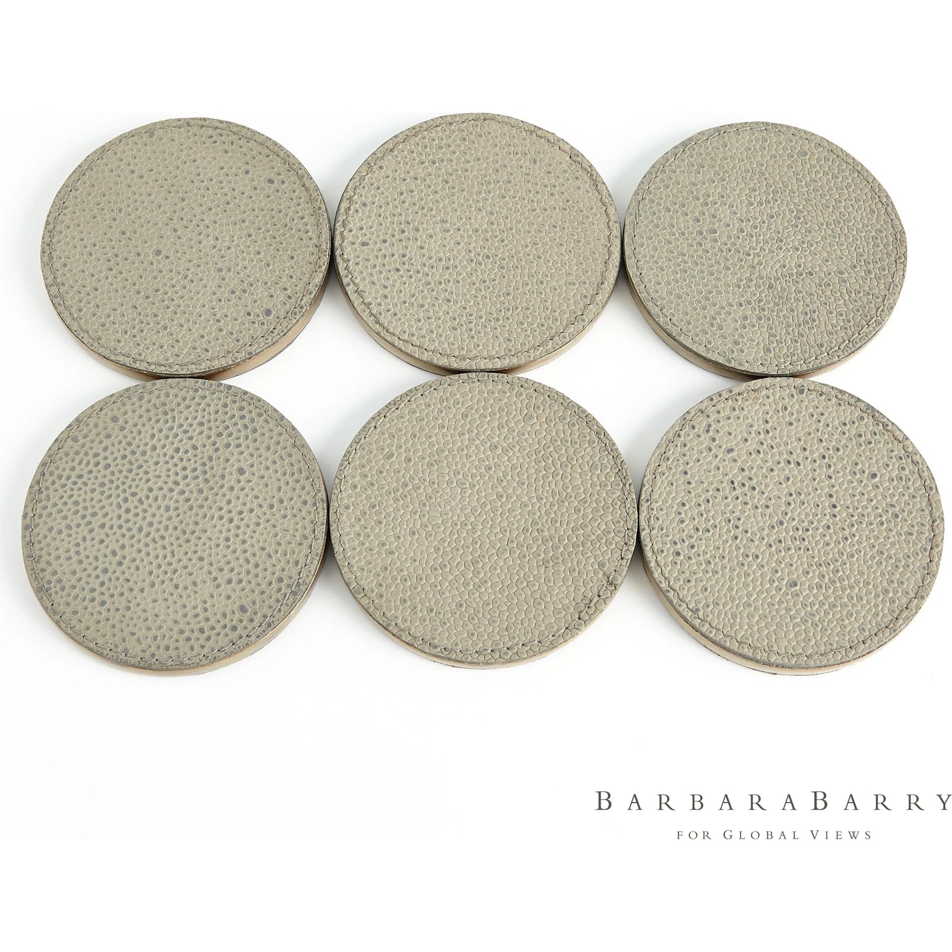 Alpen Coasters by Global Views. Made from mdf, brass, leather, polyester suede in a transitional style.