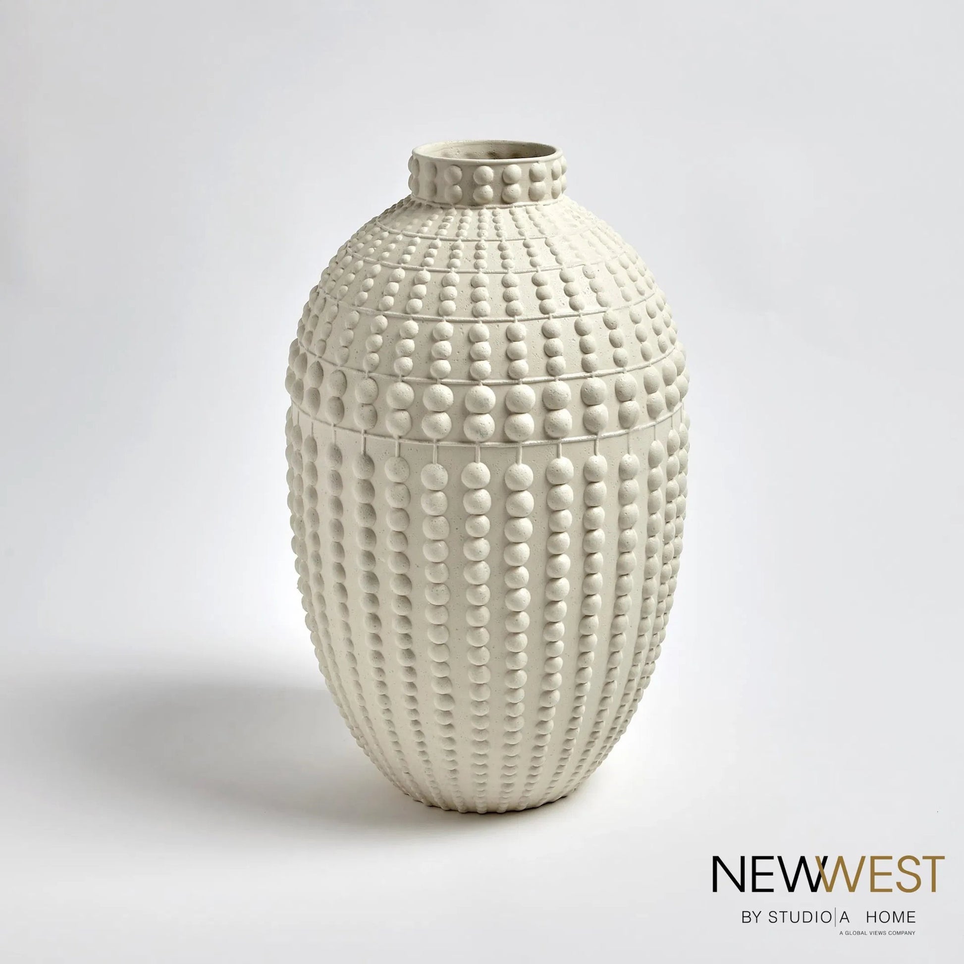 Nail Head Vase by Global Views in rustic white. Made from ceramic in a coastal style.