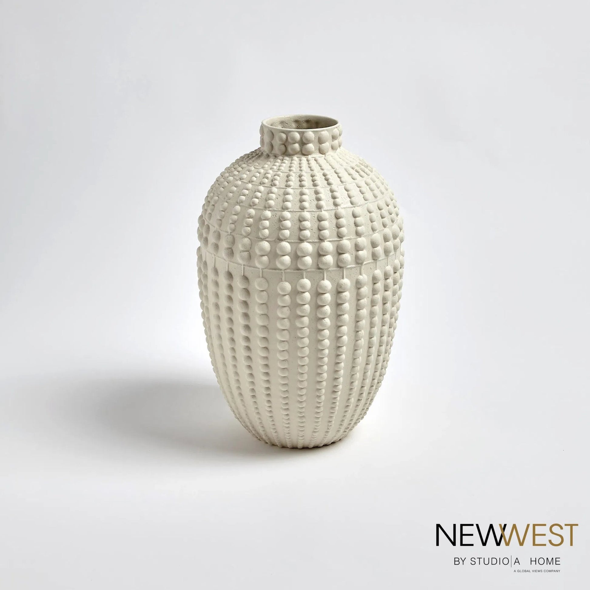 Nail Head Vase by Global Views in rustic white. Made from ceramic in a coastal style.