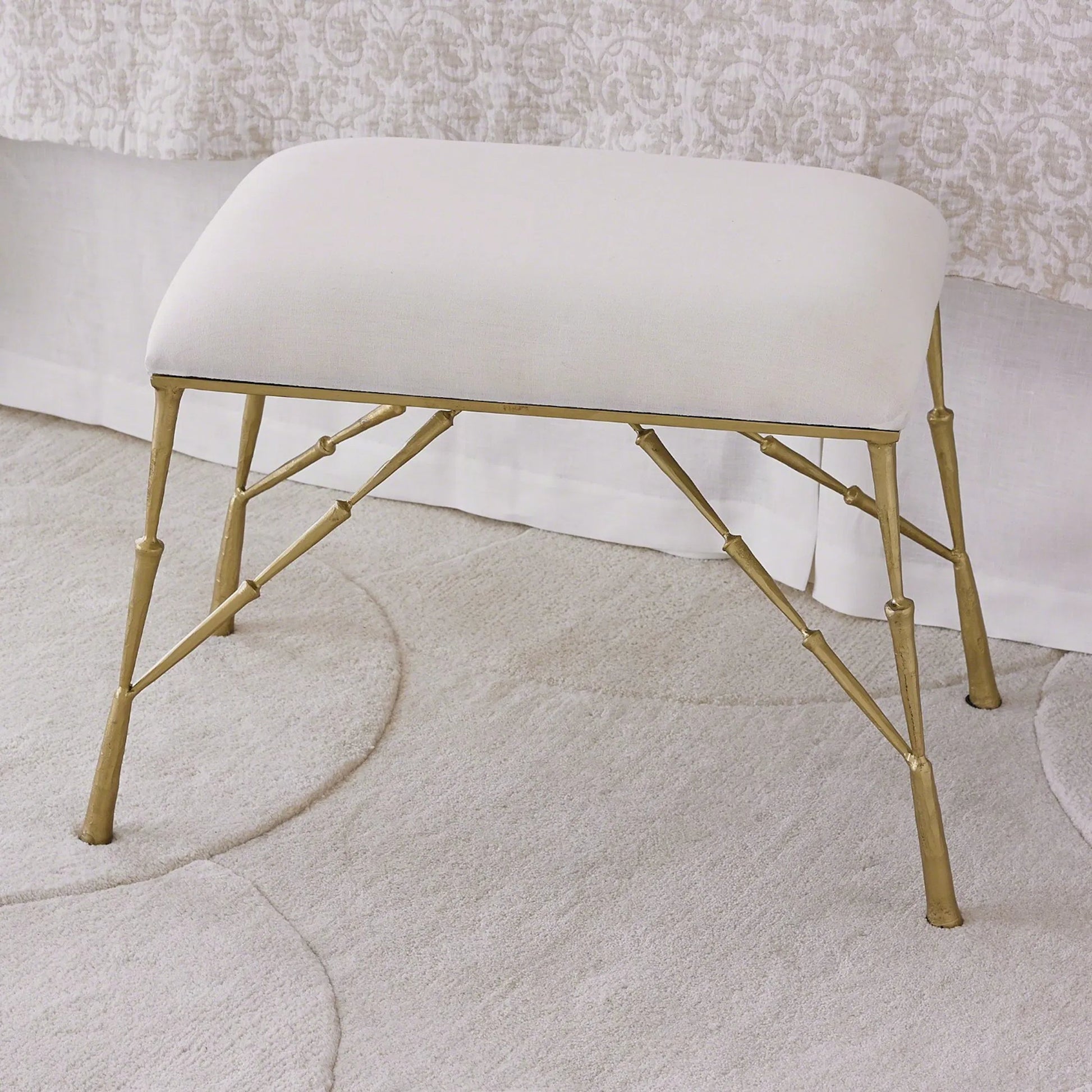 Spike Bench with Muslin Cushion by Global Views in antique brass. Made from iron in a transitional style.