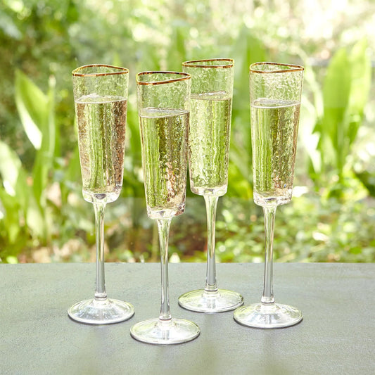 Hammered Champagne Glasses by Global Views in clear w, gold rim. Made from glass in a transitional style.