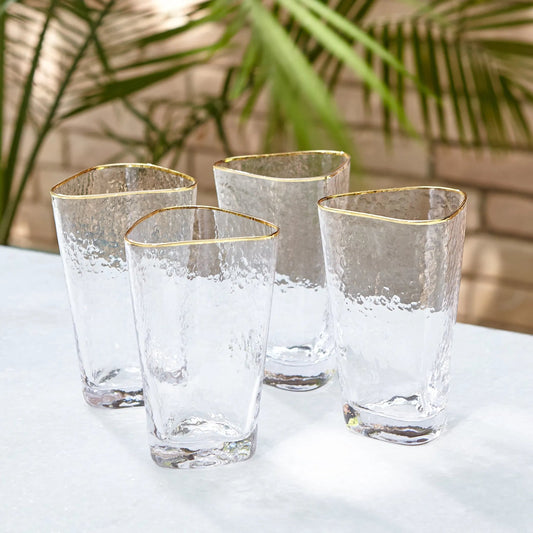 Hammered High Ball Glasses by Global Views in clear w, gold rim. Made from glass in a transitional style.