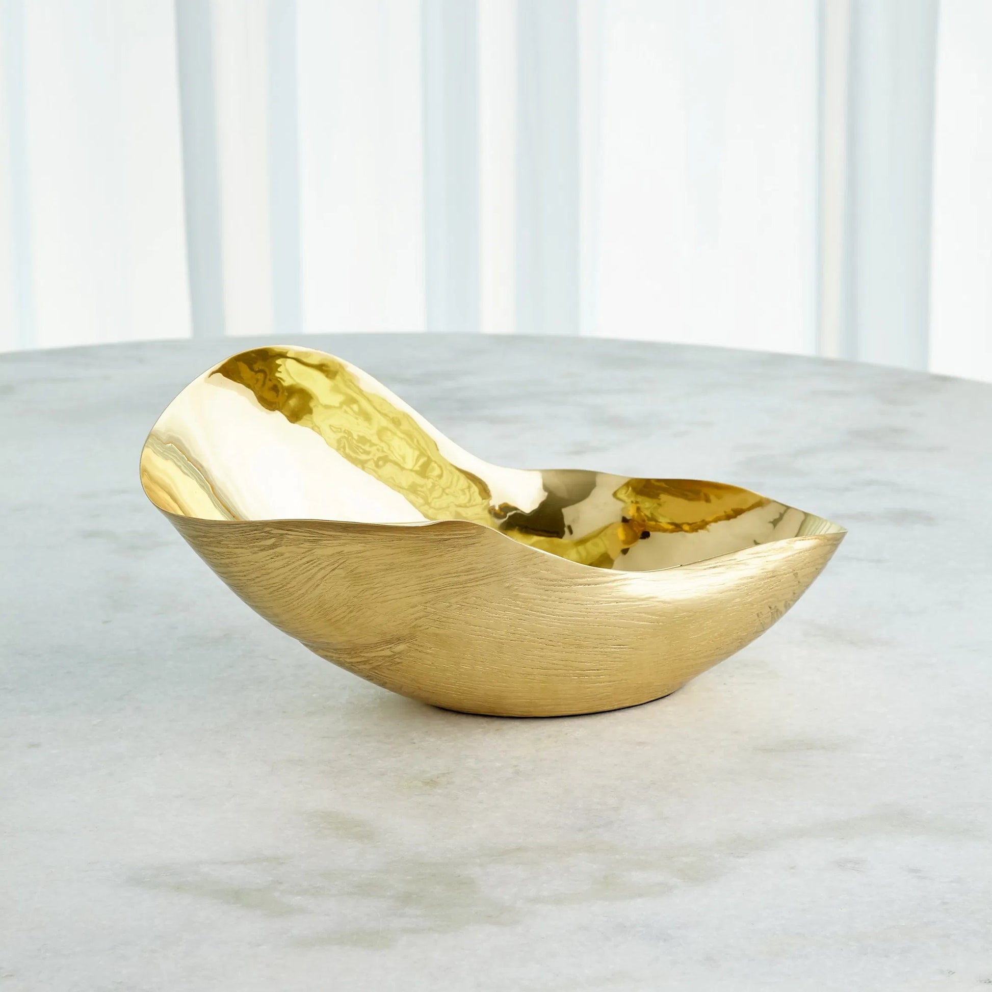 Free Form Bowl by Global Views. Made from brass in a modern style.