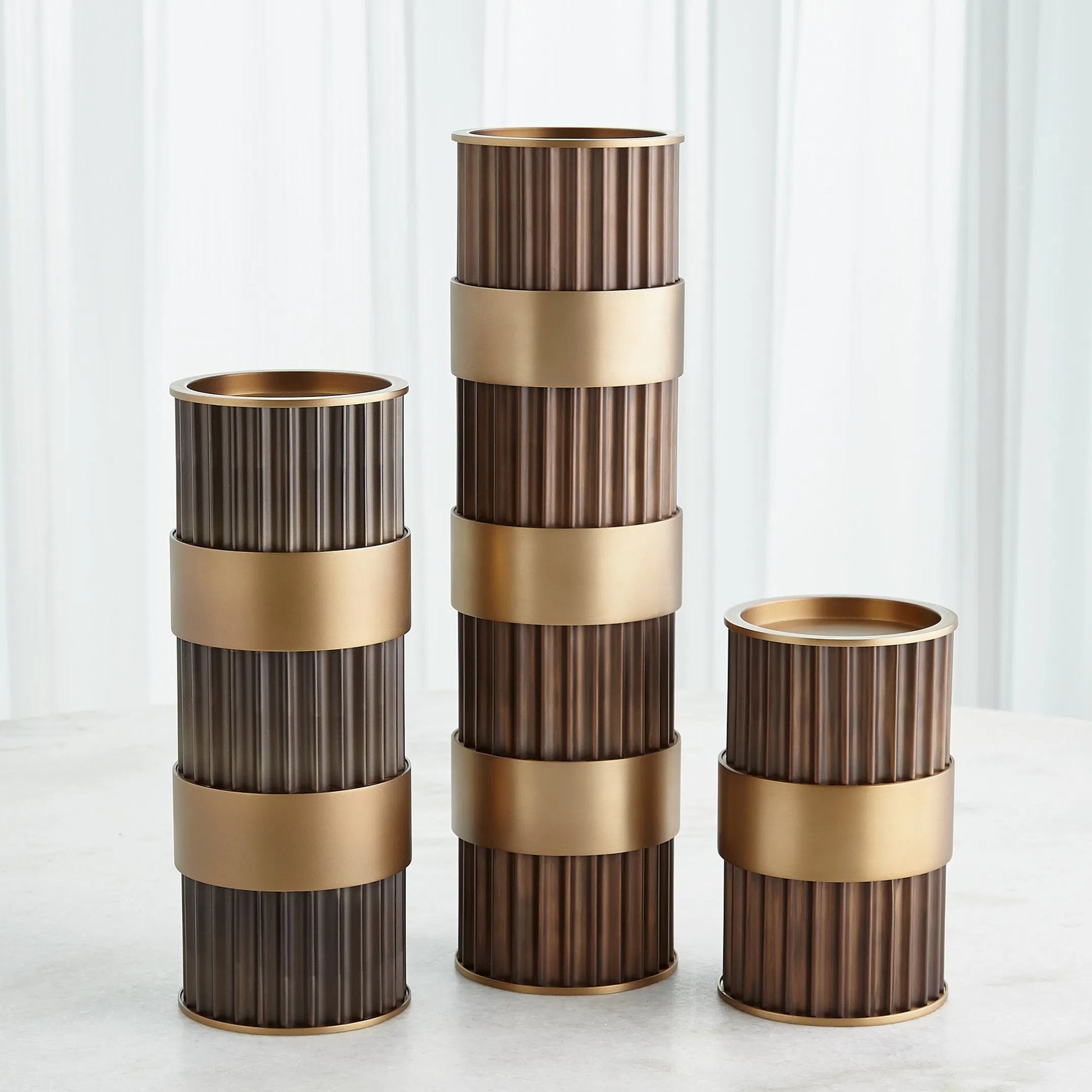 Magic Flute Cylinder Candleholder by Global Views in bronze. Made from unique in a modern style.