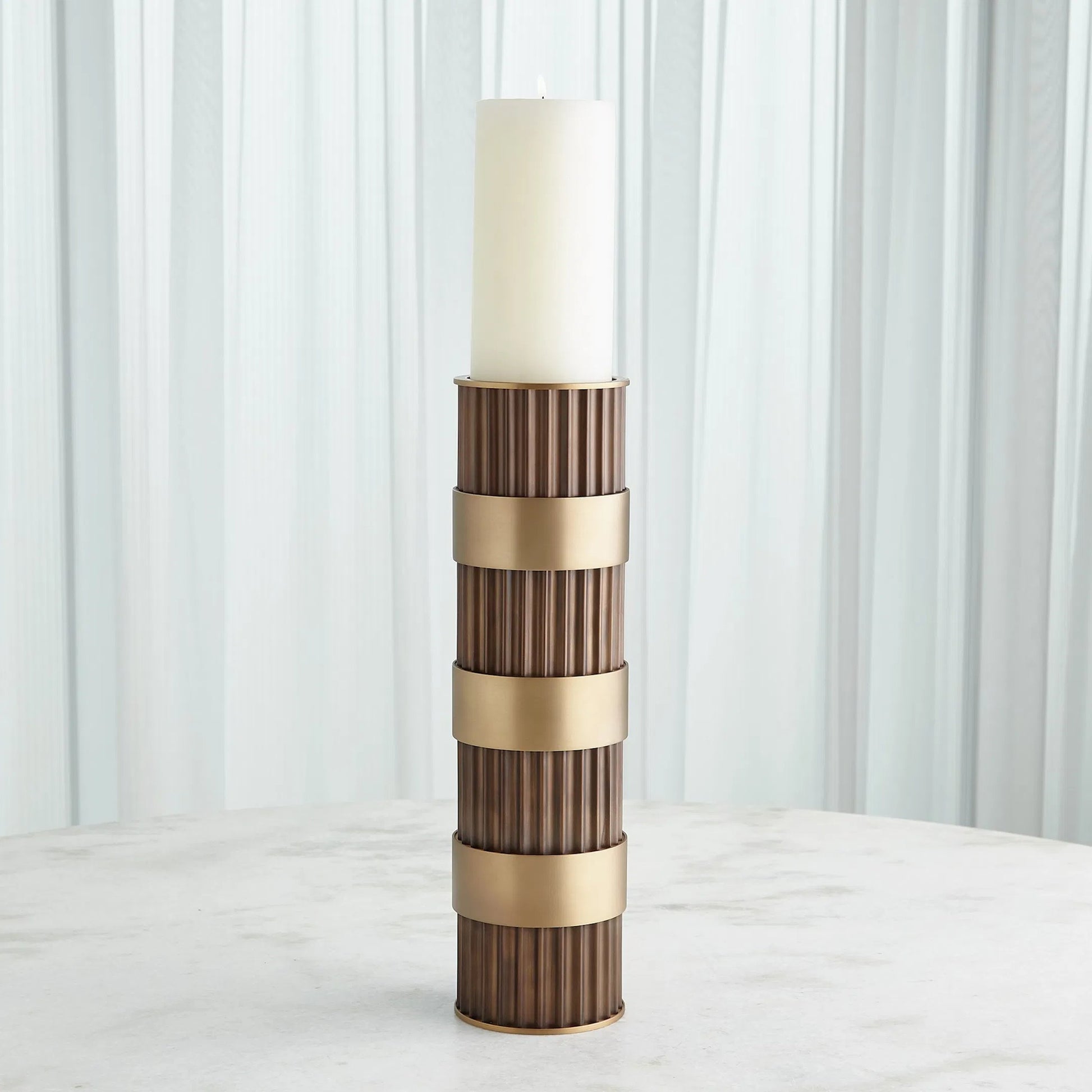 Magic Flute Cylinder Candleholder by Global Views in bronze. Made from unique in a modern style.