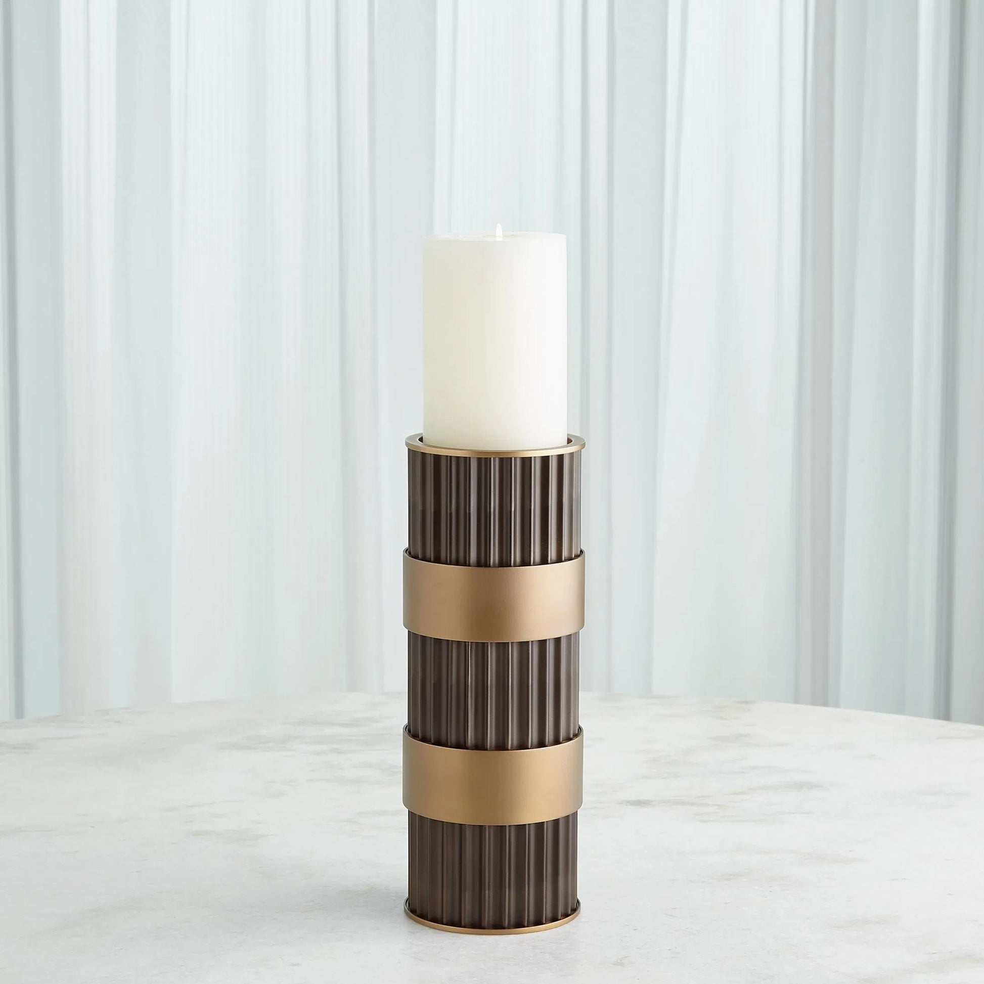 Magic Flute Cylinder Candleholder by Global Views in bronze. Made from unique in a modern style.