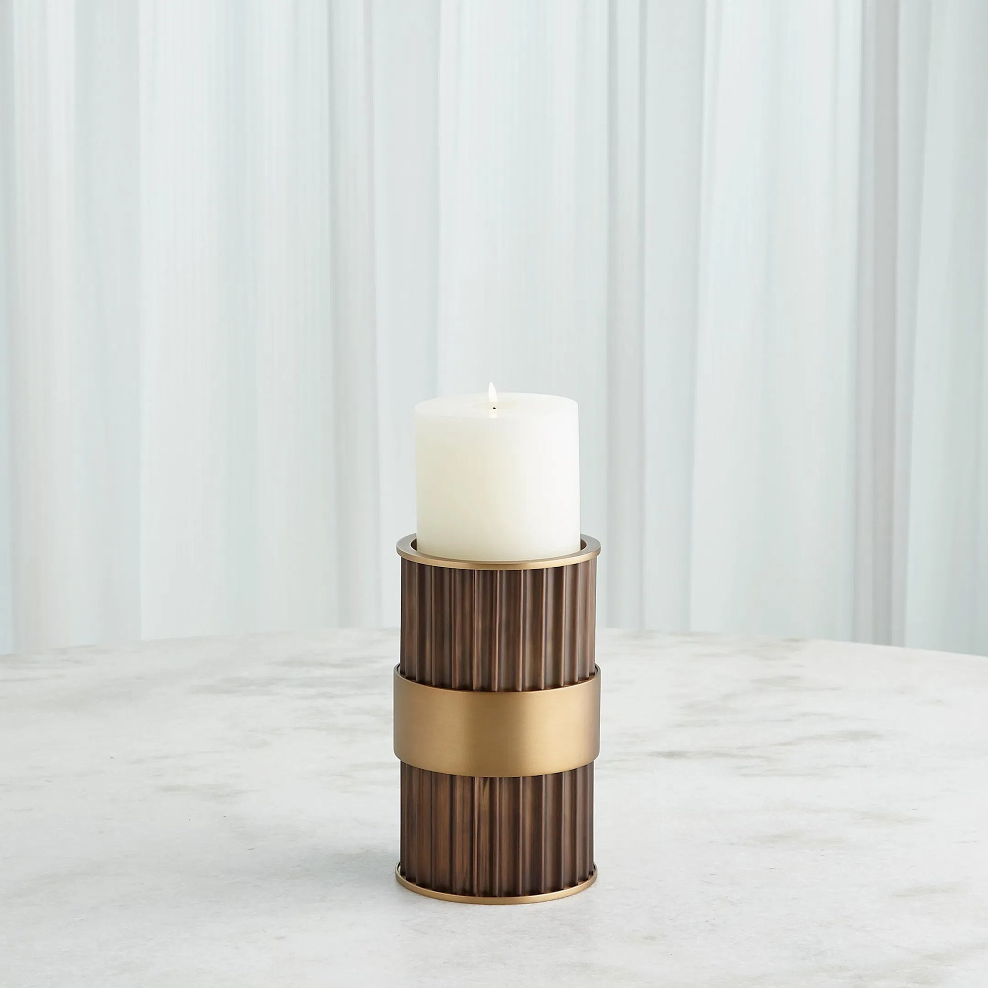 Magic Flute Cylinder Candleholder by Global Views in bronze. Made from unique in a modern style.