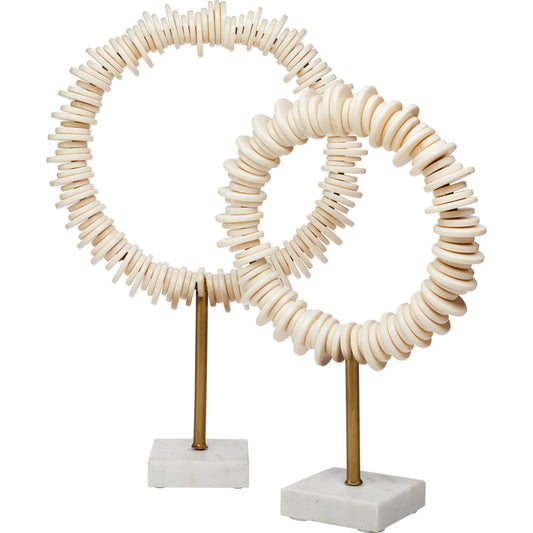 Arena Ring Sculptures by Jamie Young in cream resin, antique. brass rod, white marble base. Made from resin, iron, white marble in a coastal style.