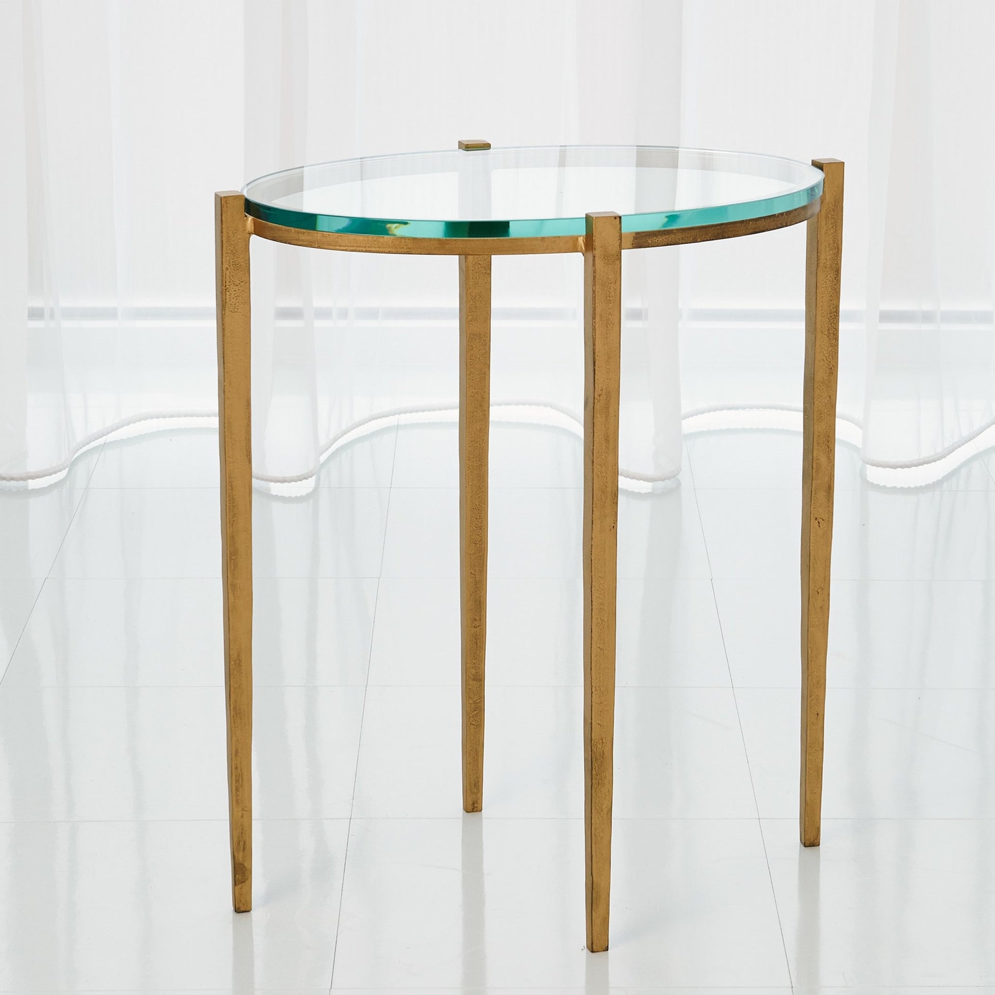 Petite Oval Accent Table by Global Views. Made from iron, tempered glass in a transitional style.
