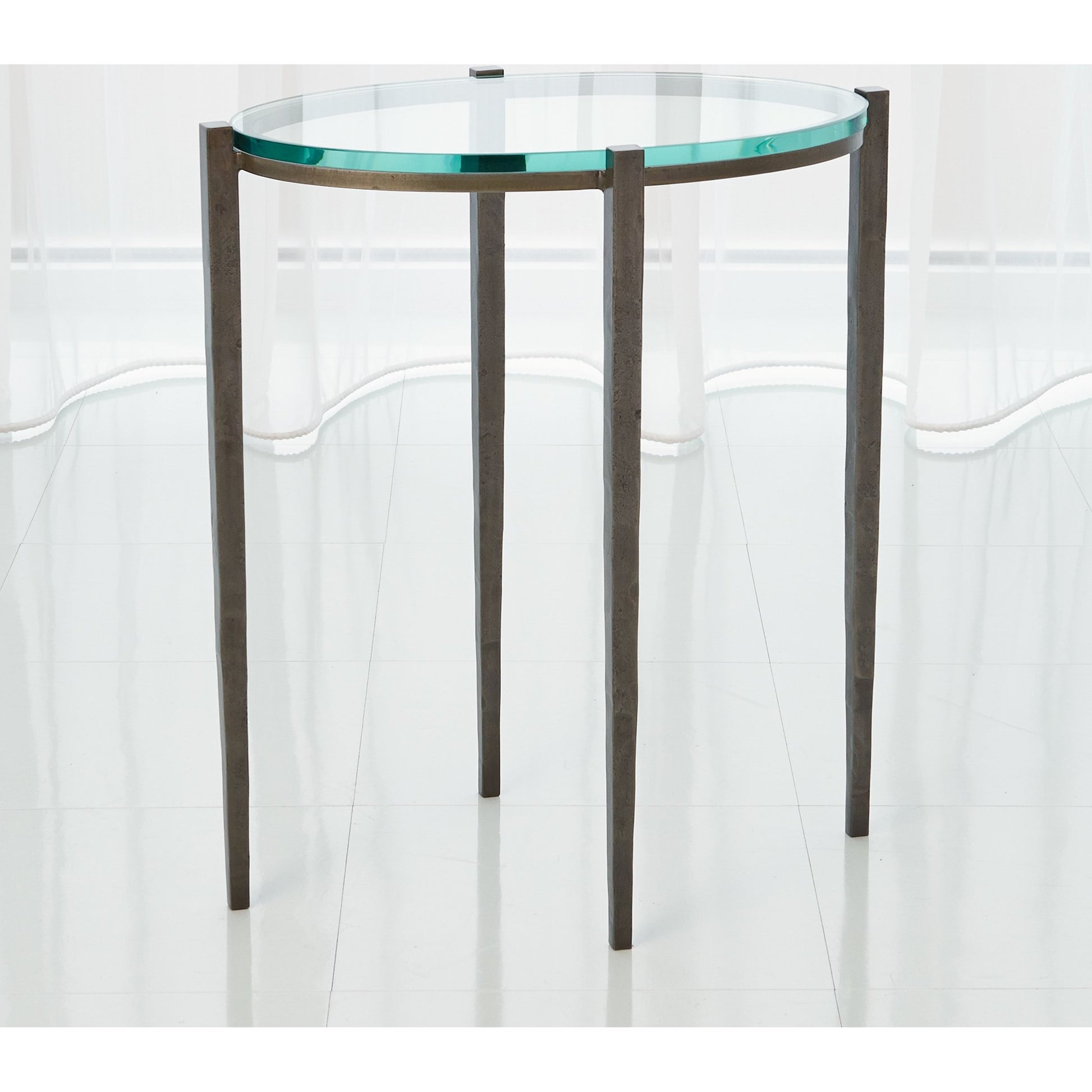Petite Oval Accent Table by Global Views. Made from iron, tempered glass in a transitional style.