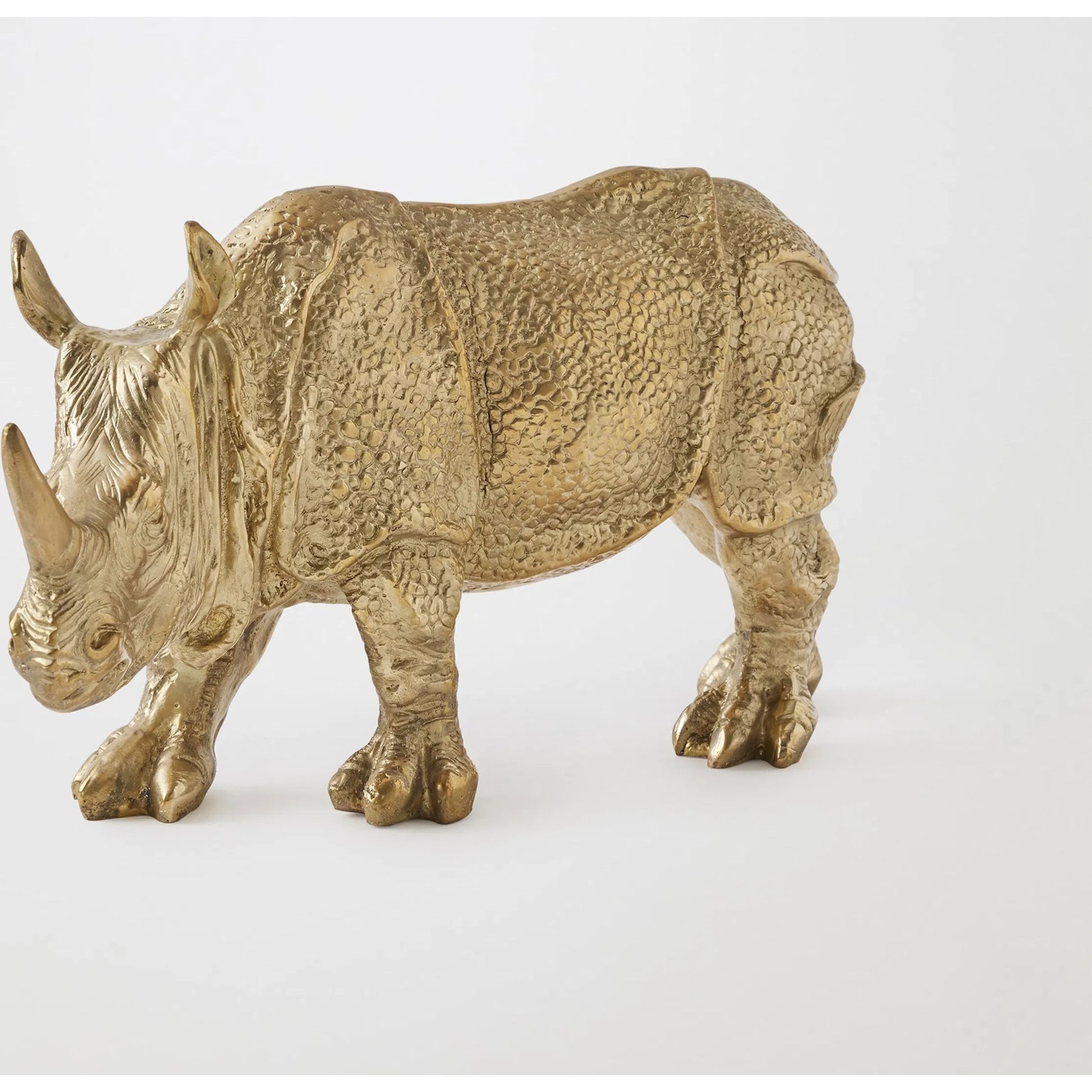 Rhino Sculpture by Global Views in brass. Made from cast brass in a modern style.