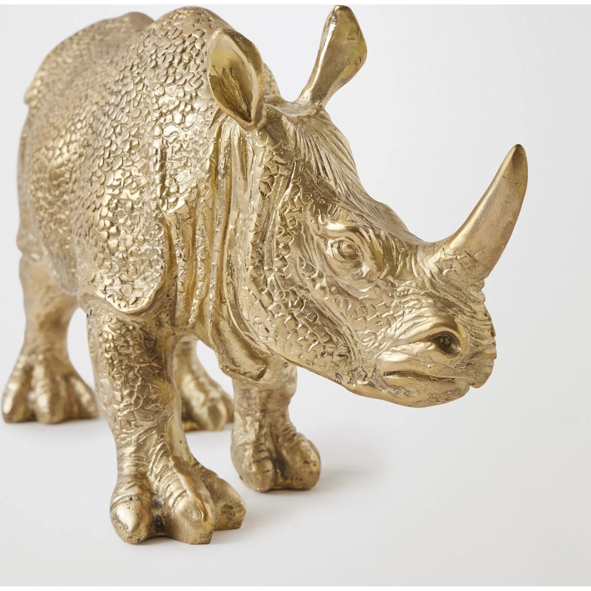 Rhino Sculpture by Global Views in brass. Made from cast brass in a modern style.