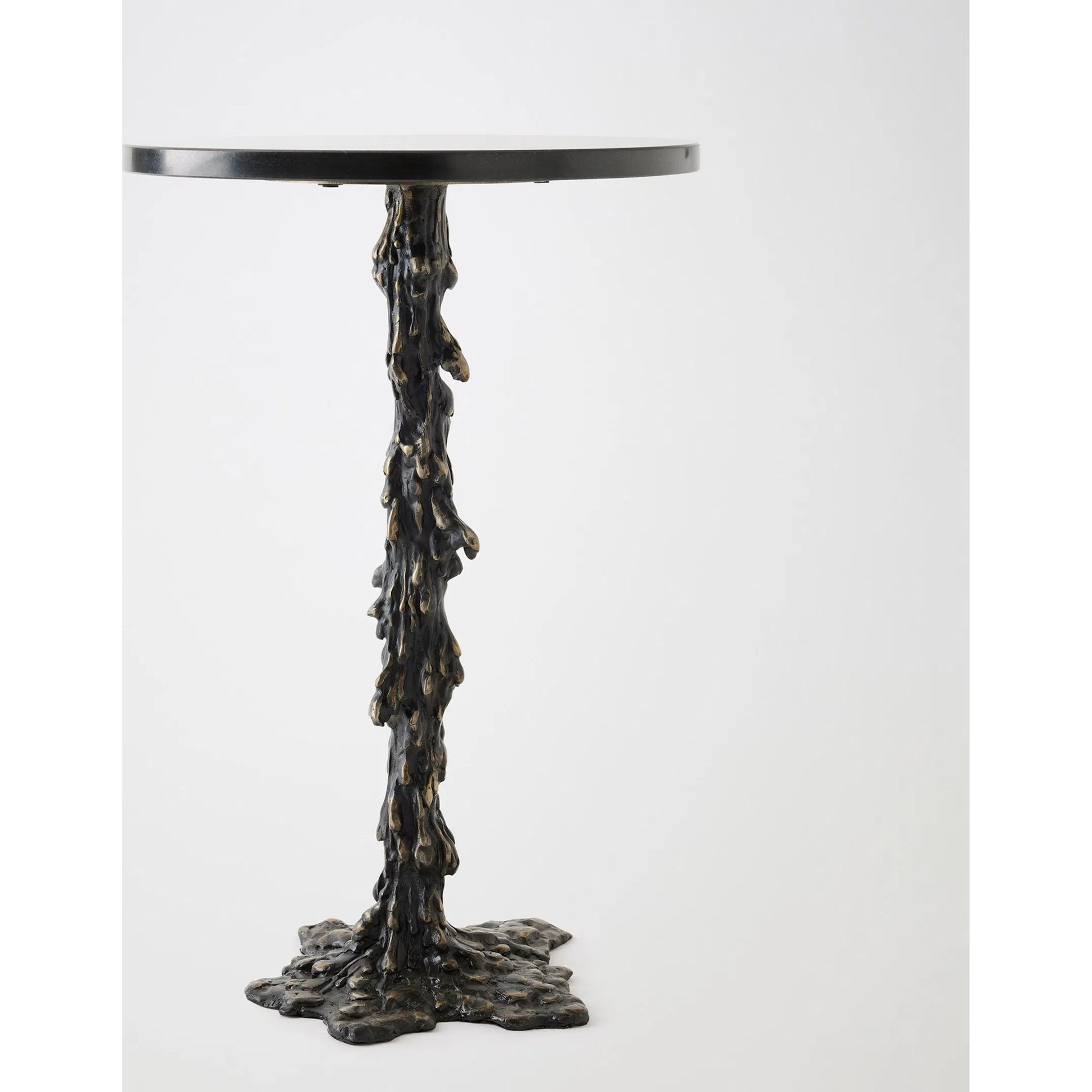 Melting Side Table by Global Views in black. Made from cast iron, granite in a rustic style.