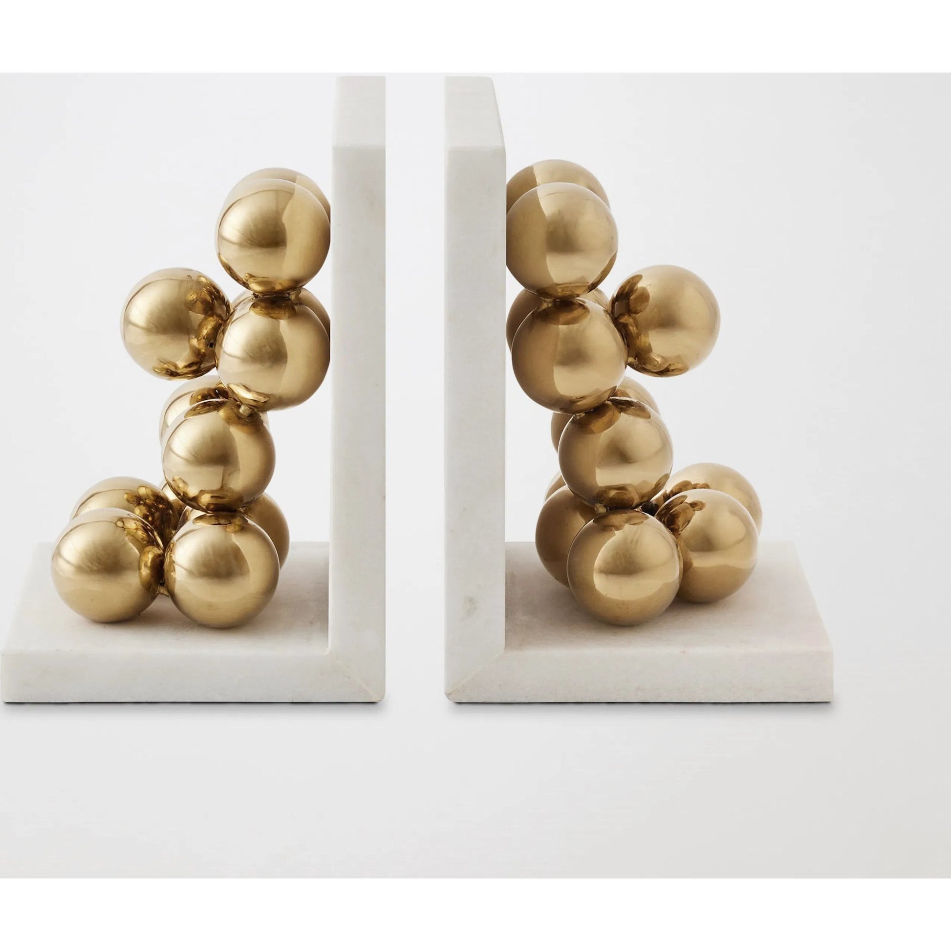 Sphere Bookends by Global Views in brass. Made from faux gold ball, white marble in a modern style.