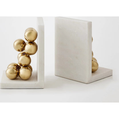 Sphere Bookends by Global Views in brass. Made from faux gold ball, white marble in a modern style.