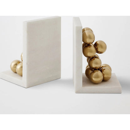 Sphere Bookends by Global Views in brass. Made from faux gold ball, white marble in a modern style.