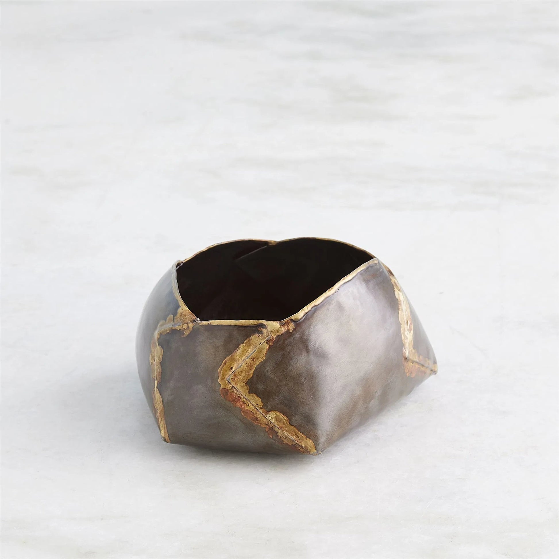 Pleated Armor Bowl by Global Views in antique gunmetal. Made from iron in a rustic style.