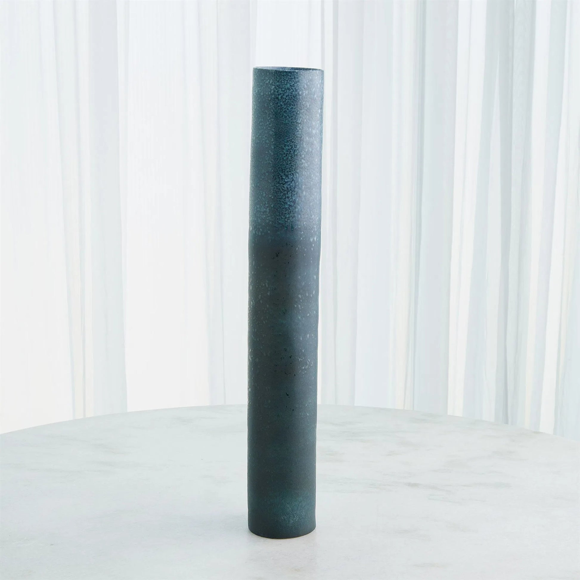 Teeter Vase by Global Views in reactive blue. Made from porcelain in a modern style.