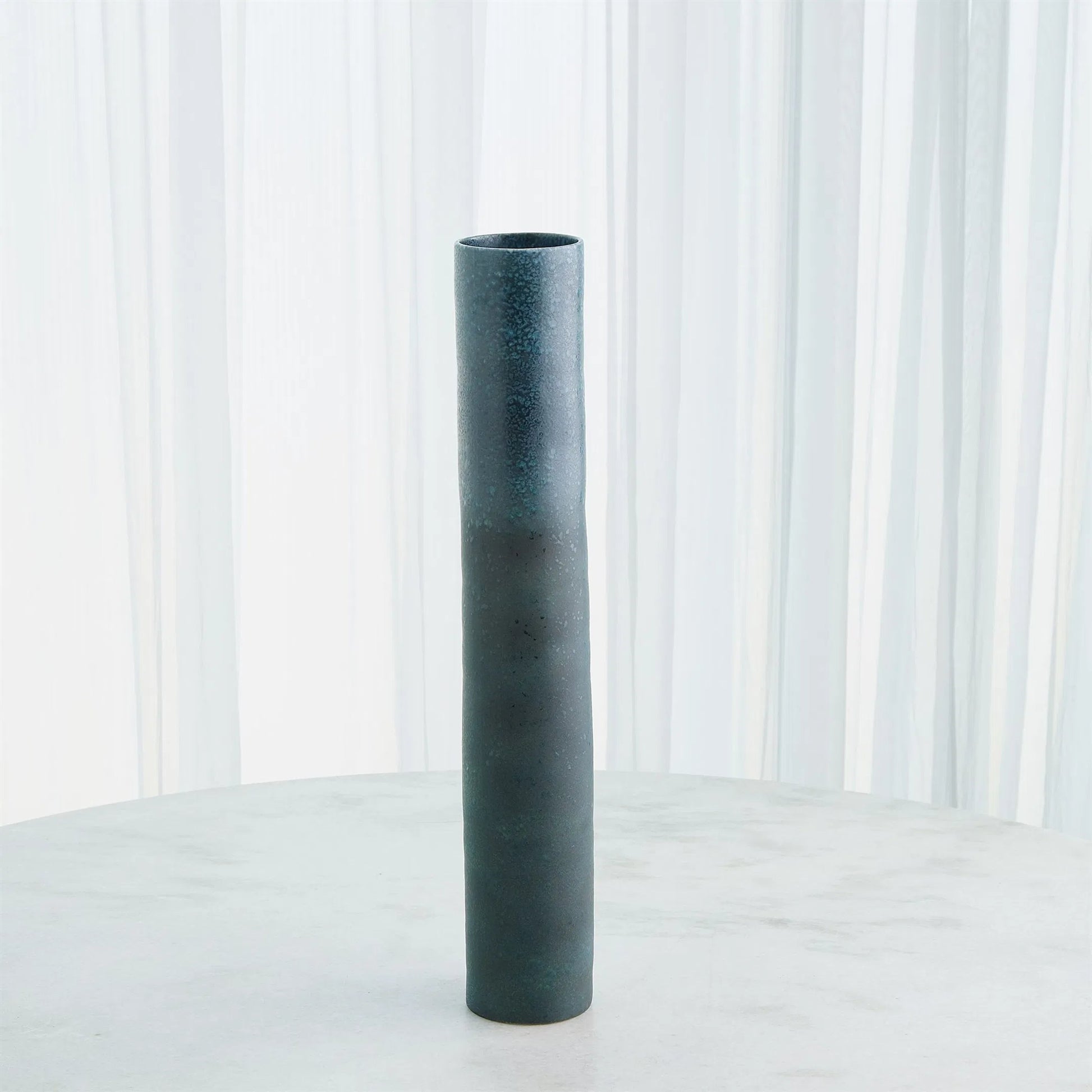 Teeter Vase by Global Views in reactive blue. Made from porcelain in a modern style.