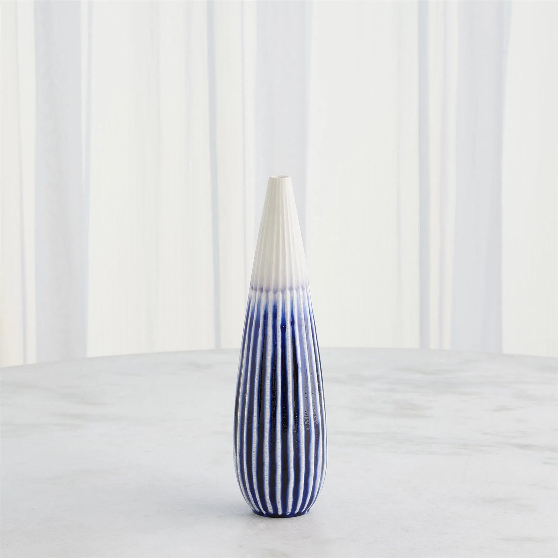 Furrow Taper Vase by Global Views. Made from ceramic in a modern style.