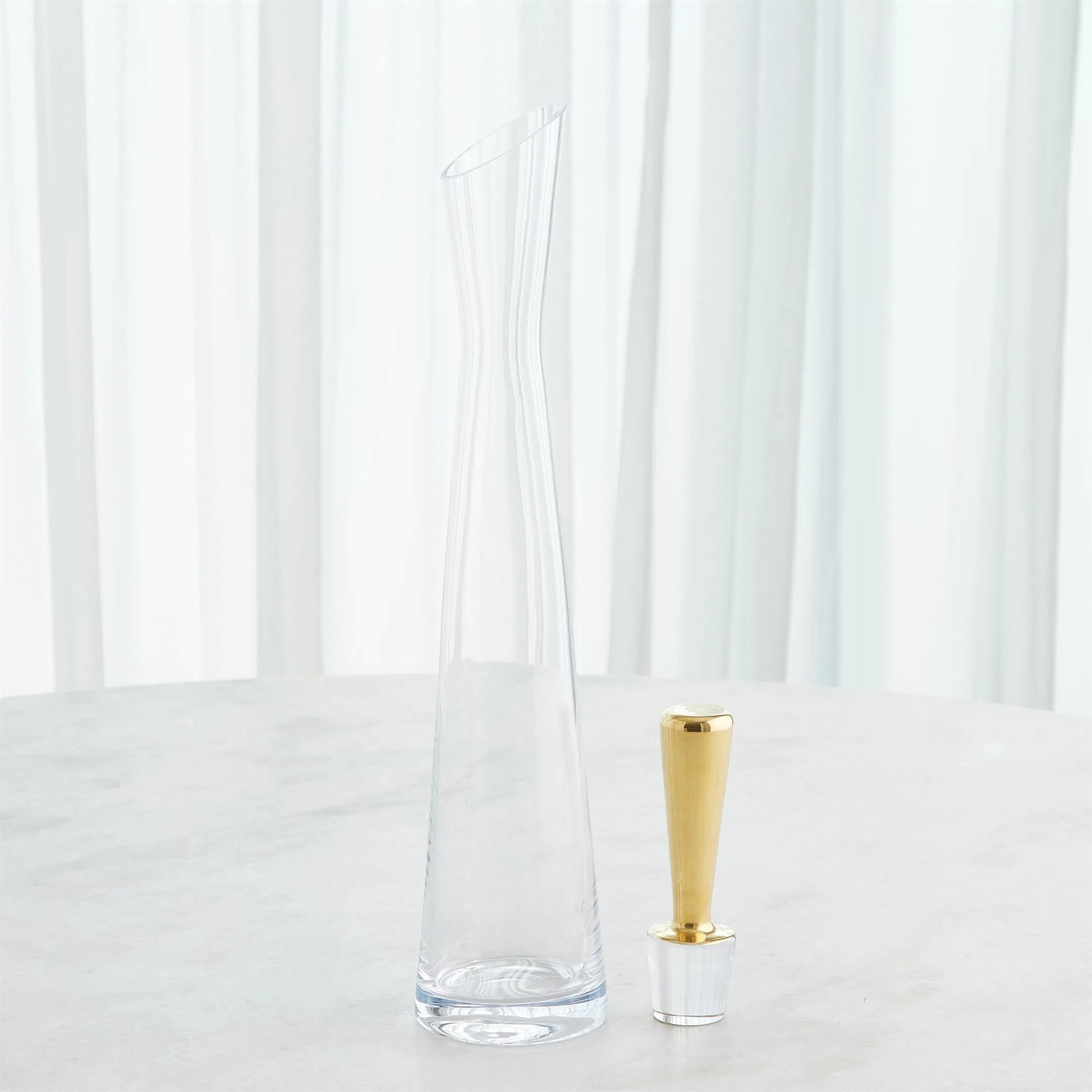 Slant Decanter by Global Views. Made from glass in a transitional style.