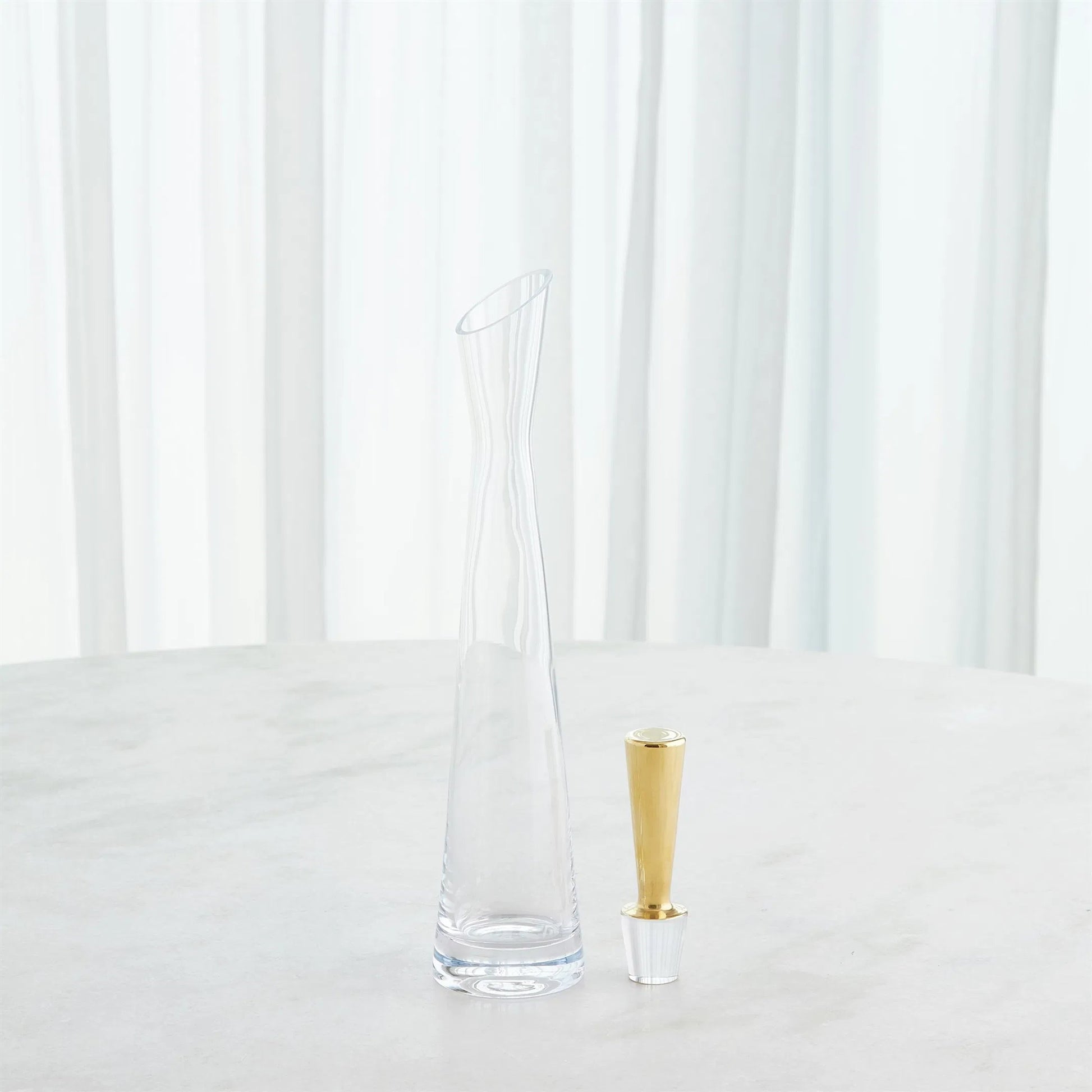 Slant Decanter by Global Views. Made from glass in a transitional style.