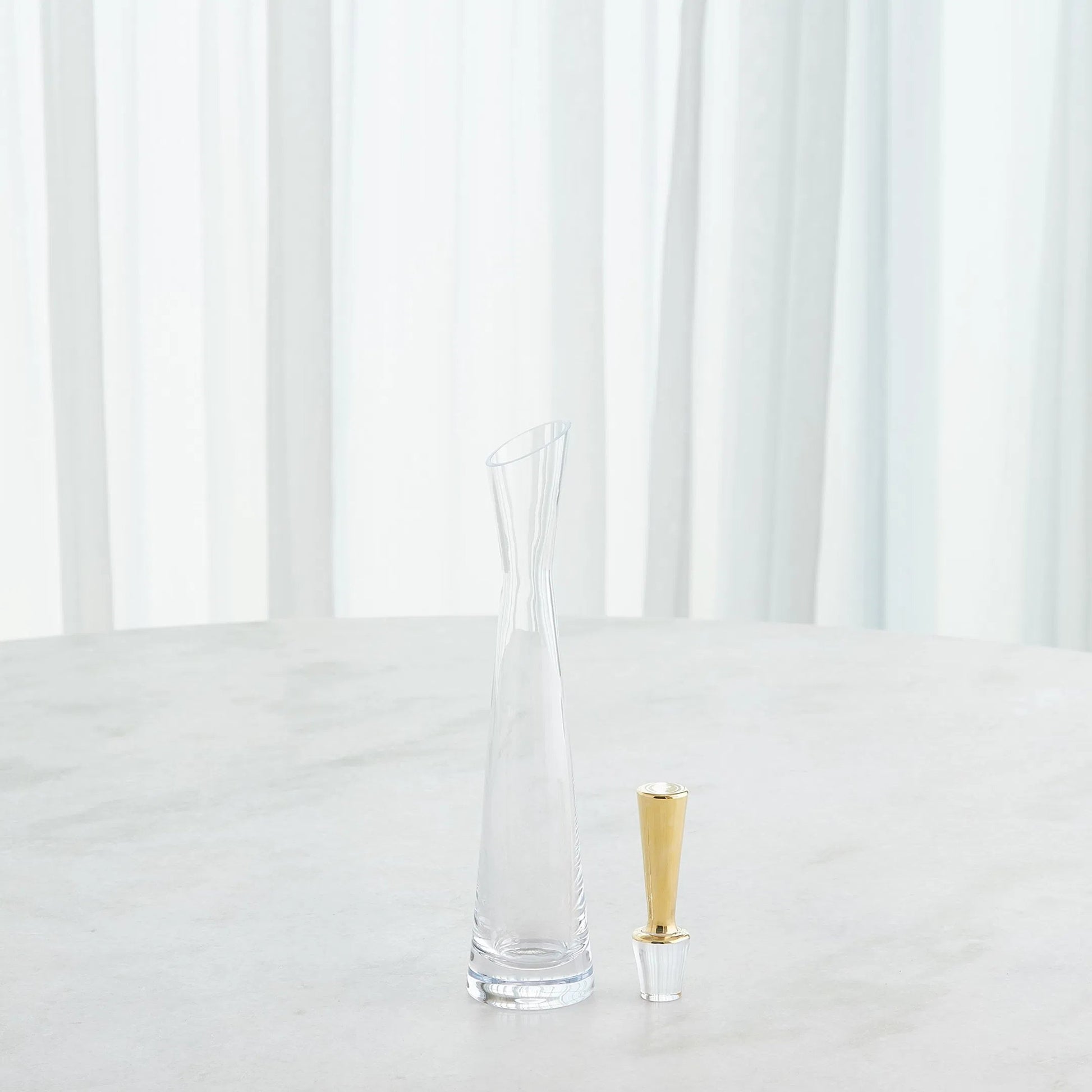 Slant Decanter by Global Views. Made from glass in a transitional style.