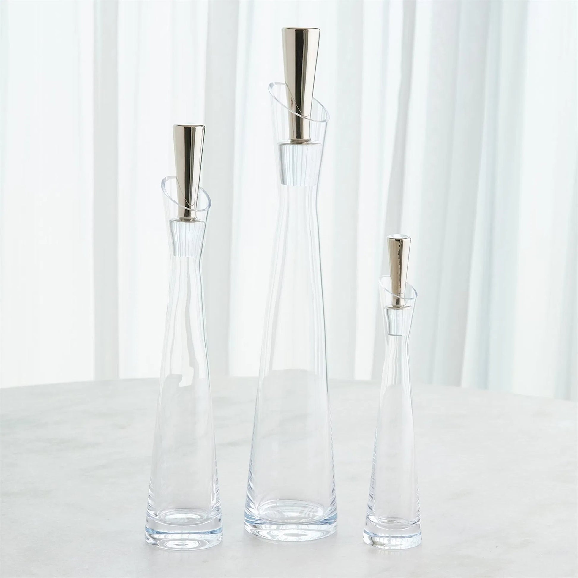 Slant Decanter by Global Views. Made from glass in a transitional style.
