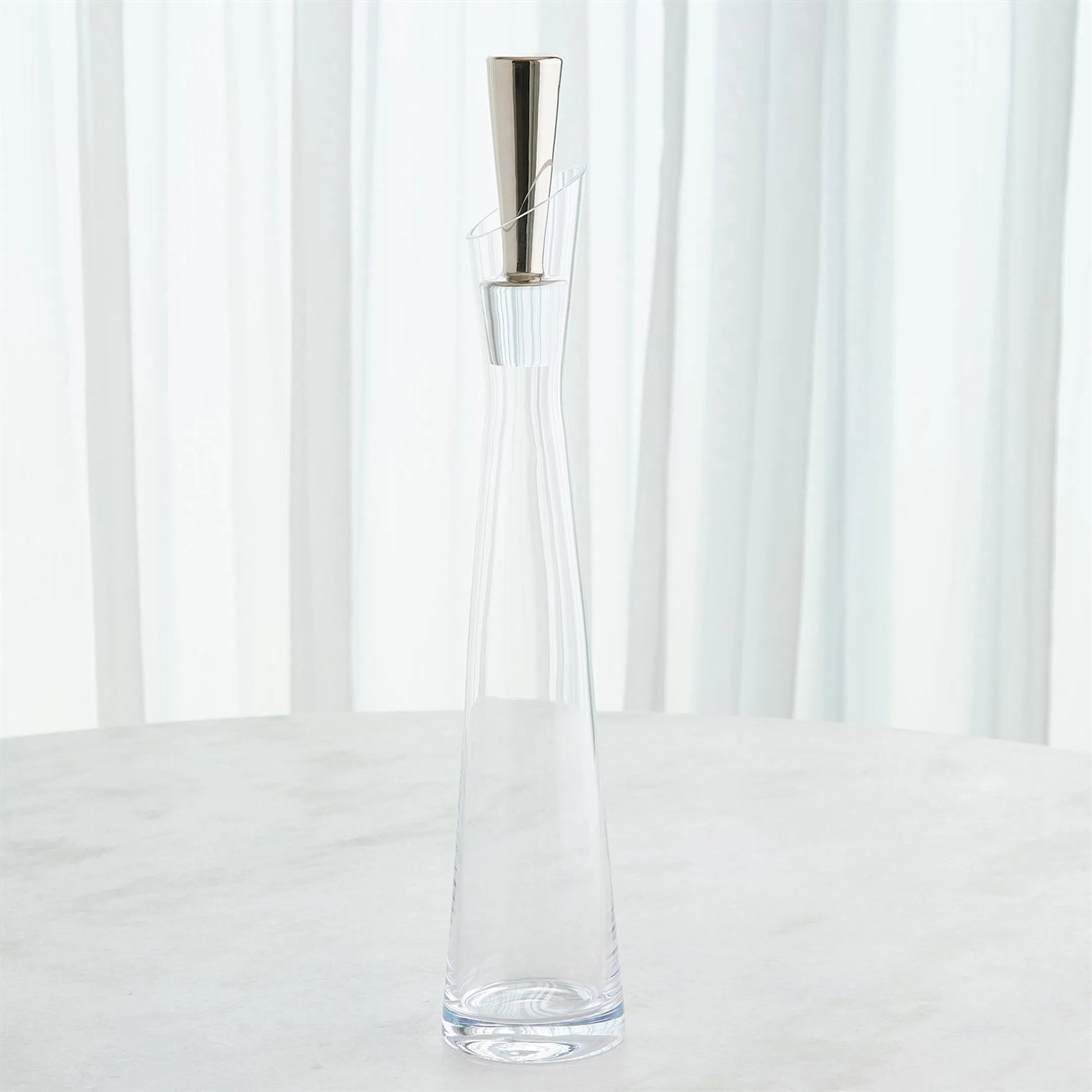 Slant Decanter by Global Views. Made from glass in a transitional style.