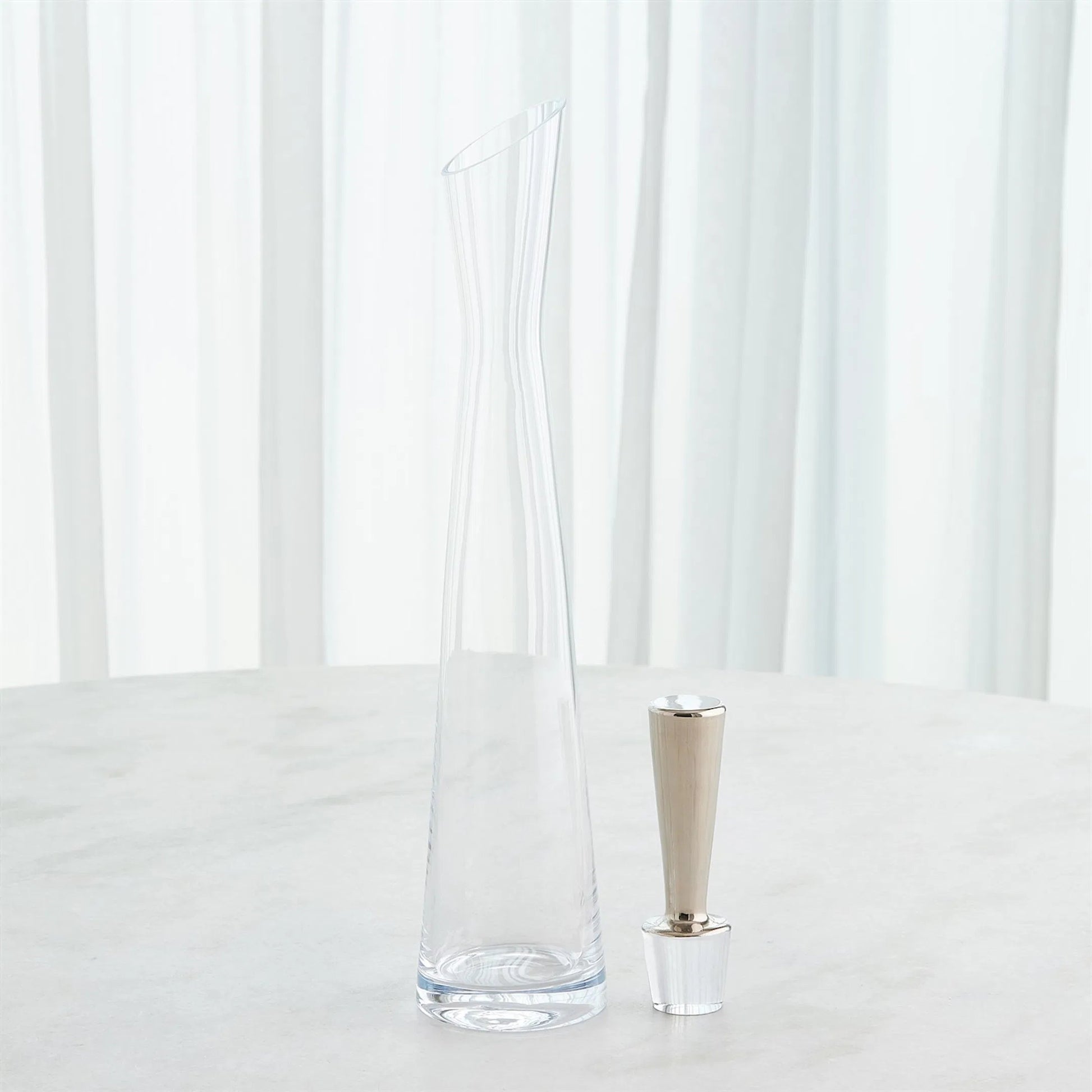 Slant Decanter by Global Views. Made from glass in a transitional style.