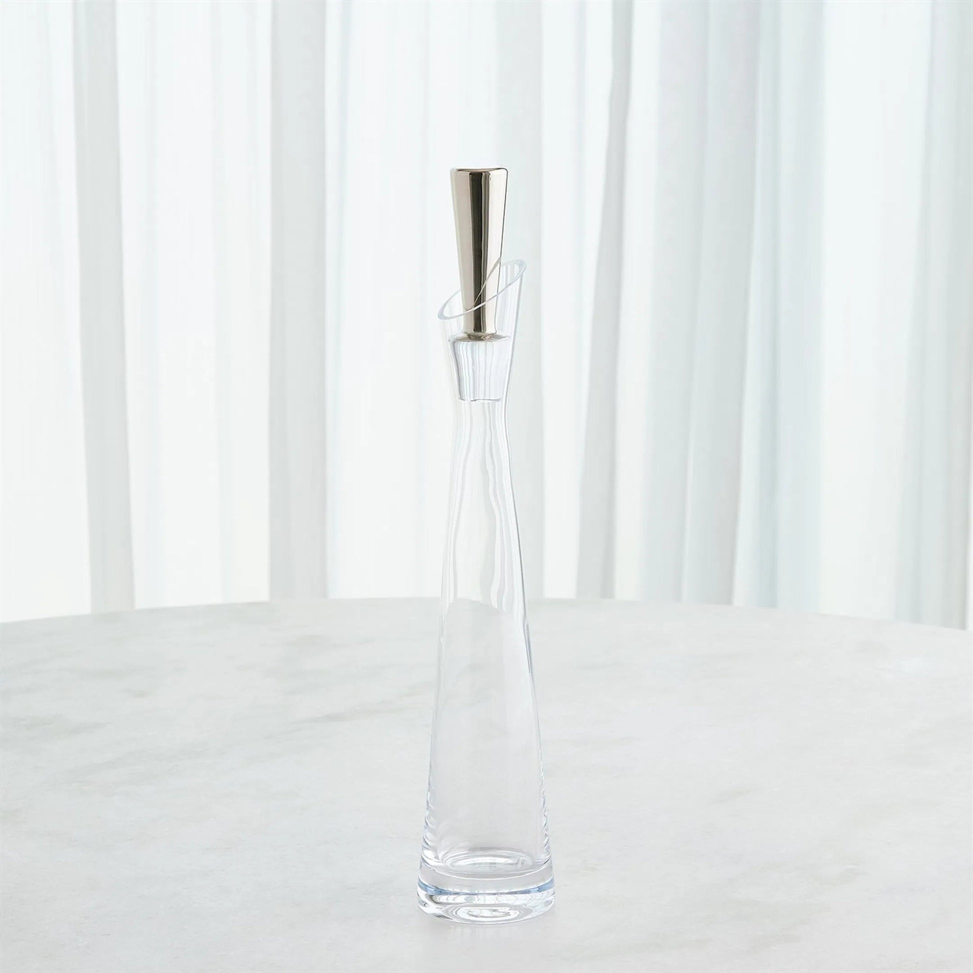 Slant Decanter by Global Views. Made from glass in a transitional style.