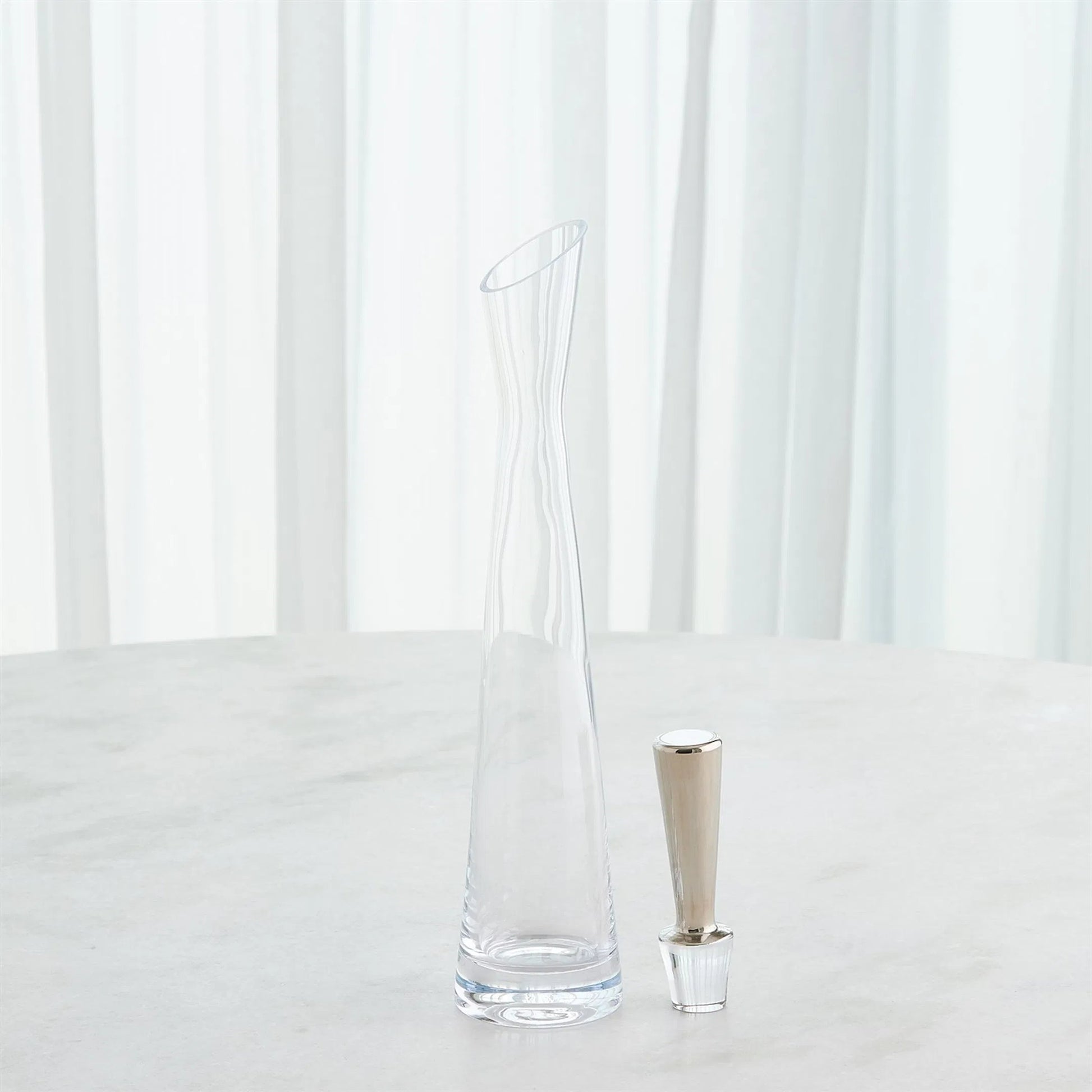 Slant Decanter by Global Views. Made from glass in a transitional style.