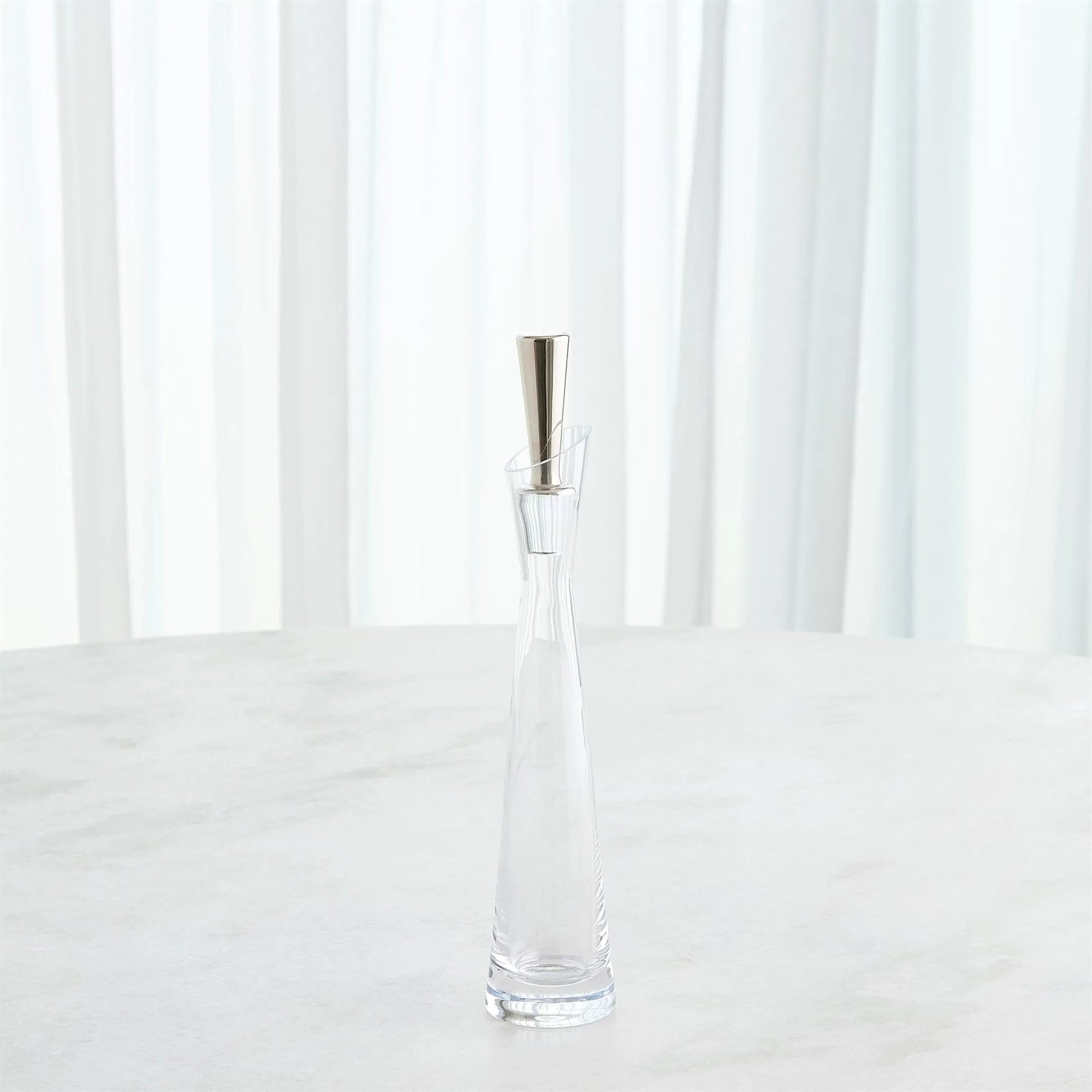 Slant Decanter by Global Views. Made from glass in a transitional style.