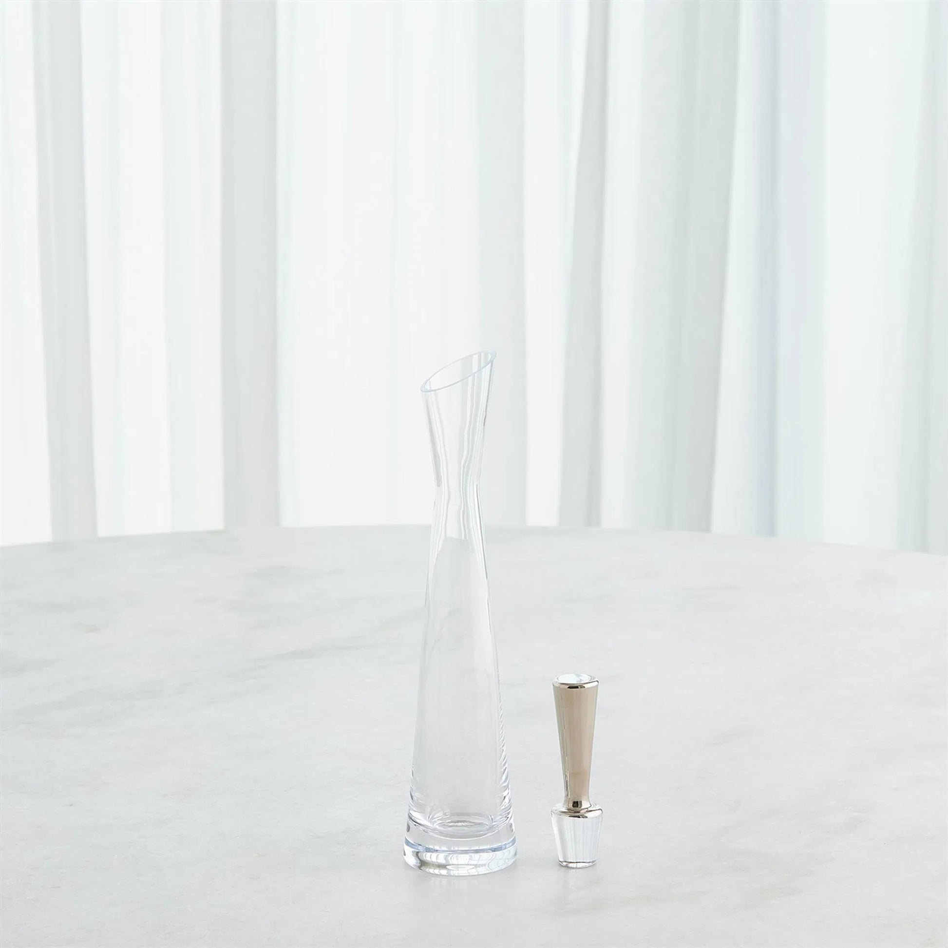 Slant Decanter by Global Views. Made from glass in a transitional style.