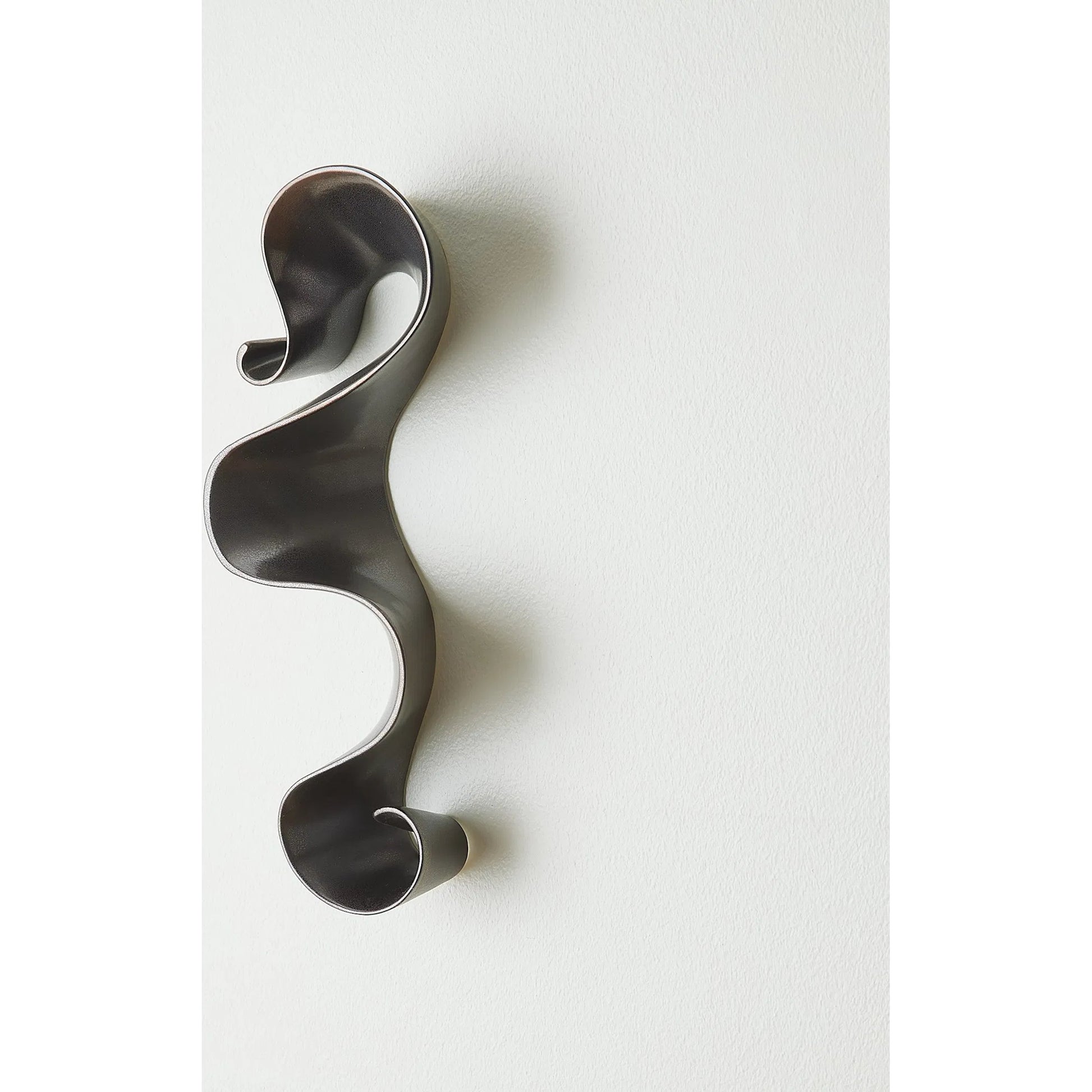 Tempest Wall Ribbon by Global Views. Made from ceramic in a modern style.