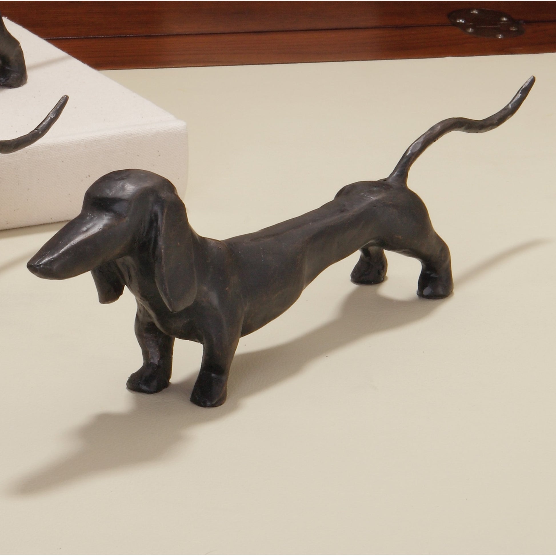 Dachshund Hound Sculpture by Global Views in bronze. Made from cast iron in a eclectic & global style.